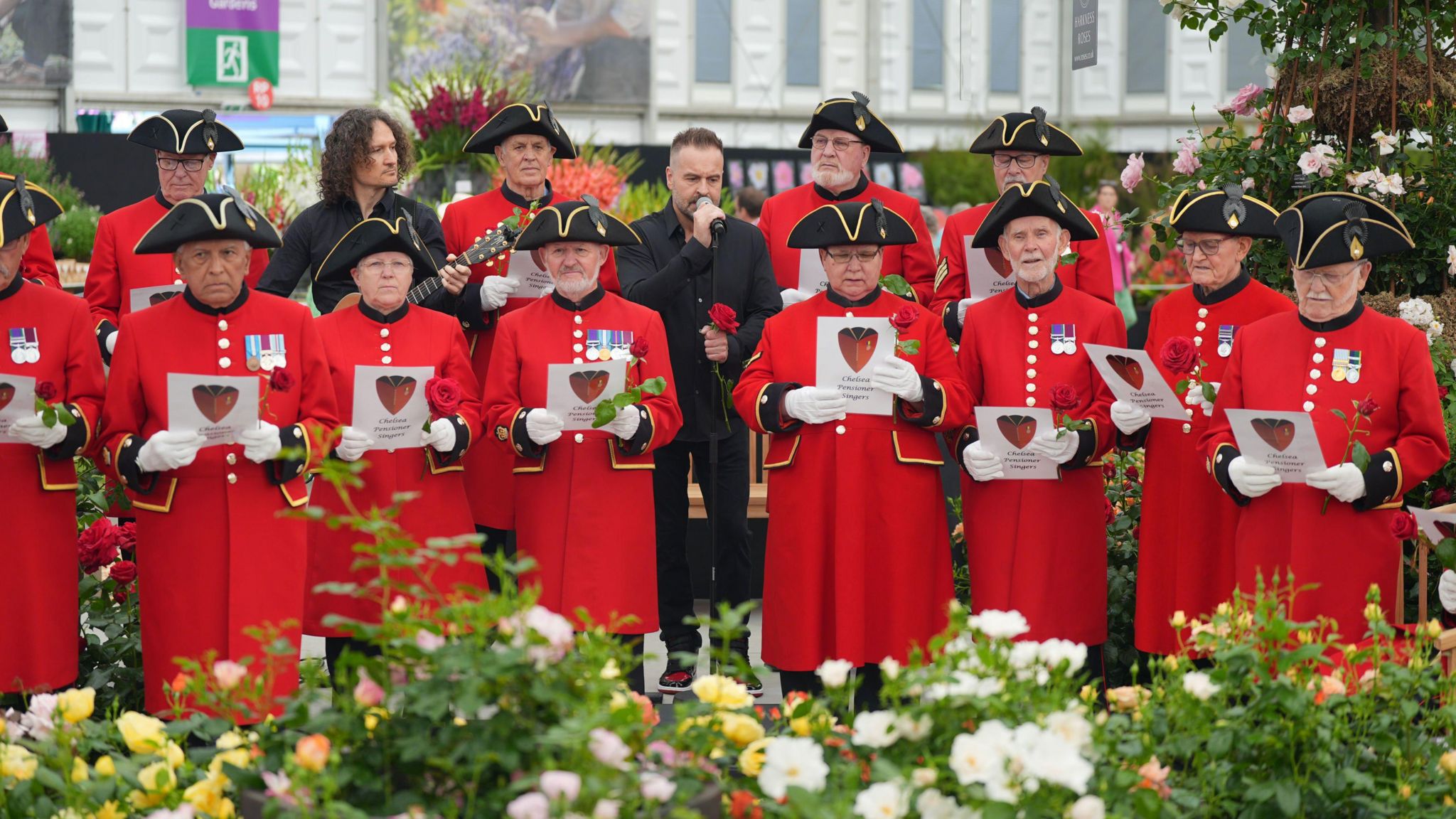 Alfie Boe performs with the Chelsea Pensioners singing group to celebrate the launch of the Harkness Roses Chelsea Pensioner rose