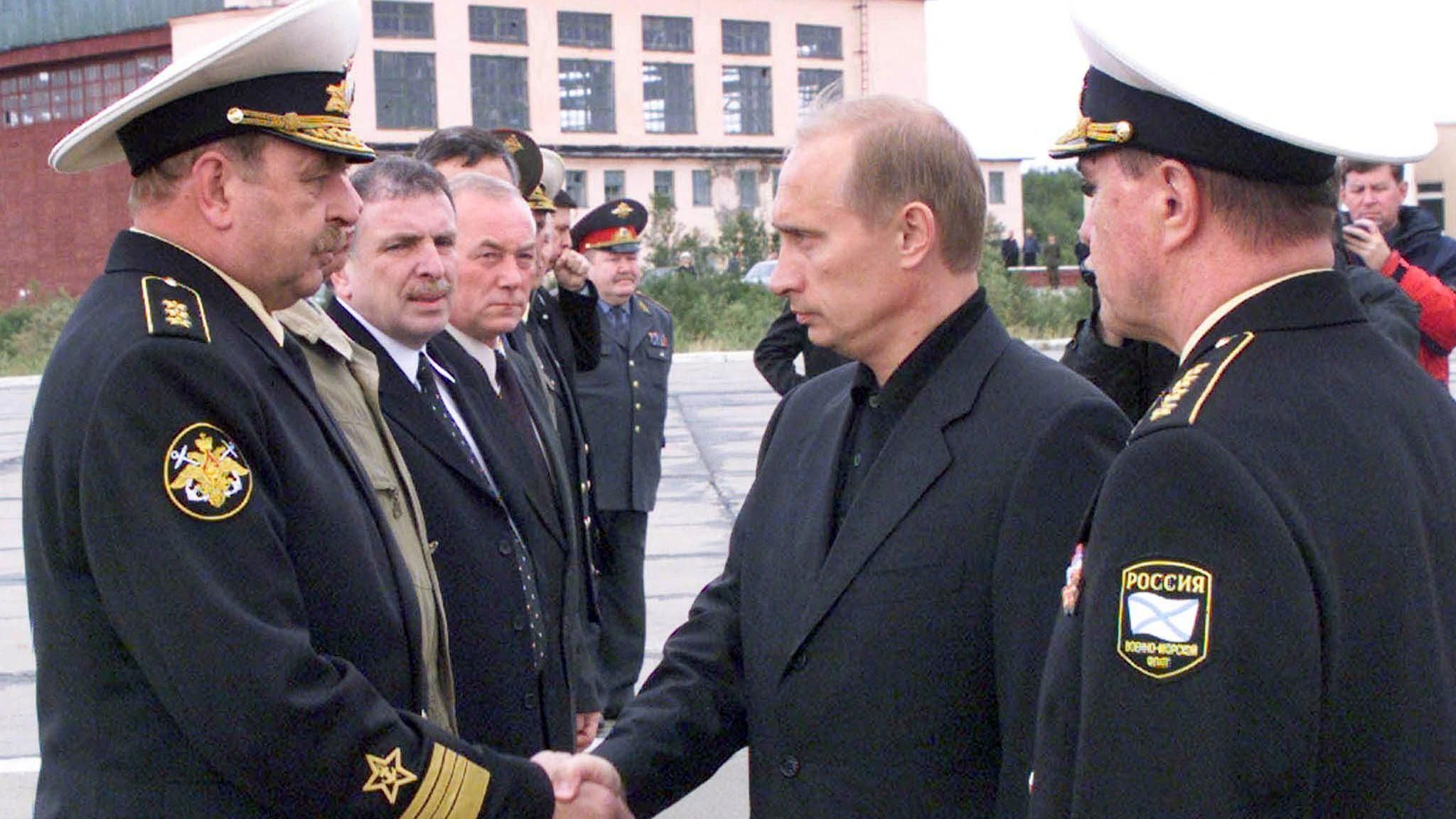 Vladimir Putin shakes hands with Russian Navy Commander Vladimir Kuroyedov (L) after the sinking of the Kursk submarine in 2000