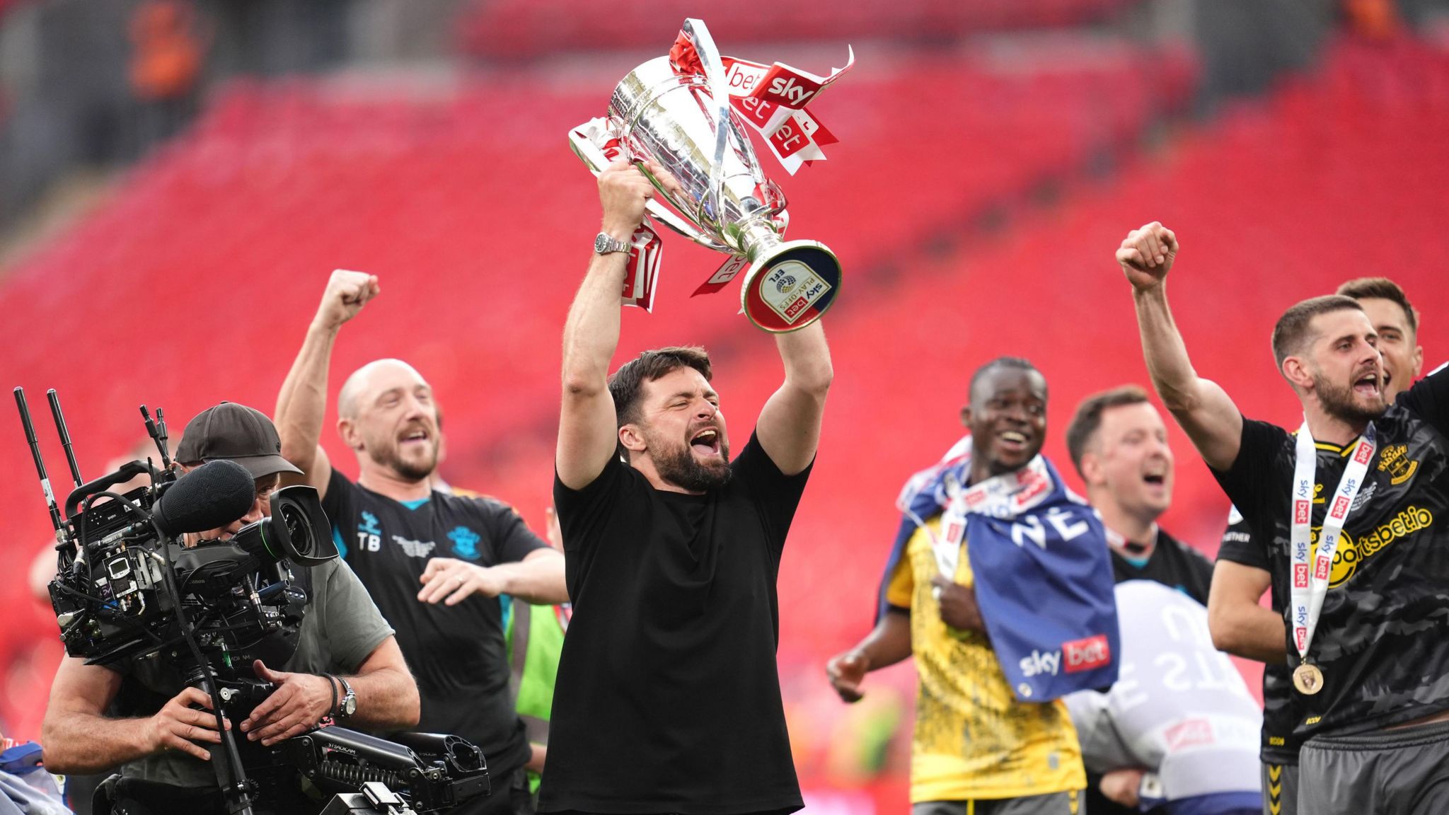 Russell Martin lifts the Championship play-off trophy after his side won the final at Wembley