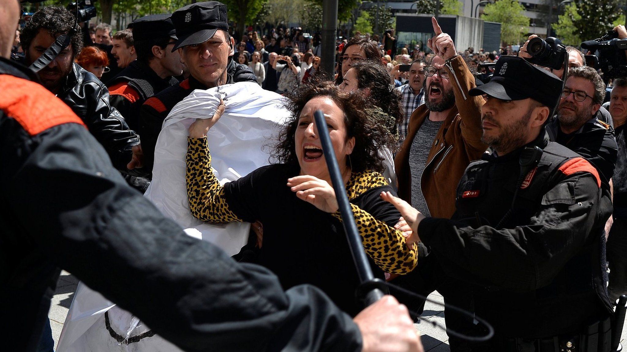 A protester breaks through a police line after a nine-year sentence was given to five men accused of the multiple rape of a woman