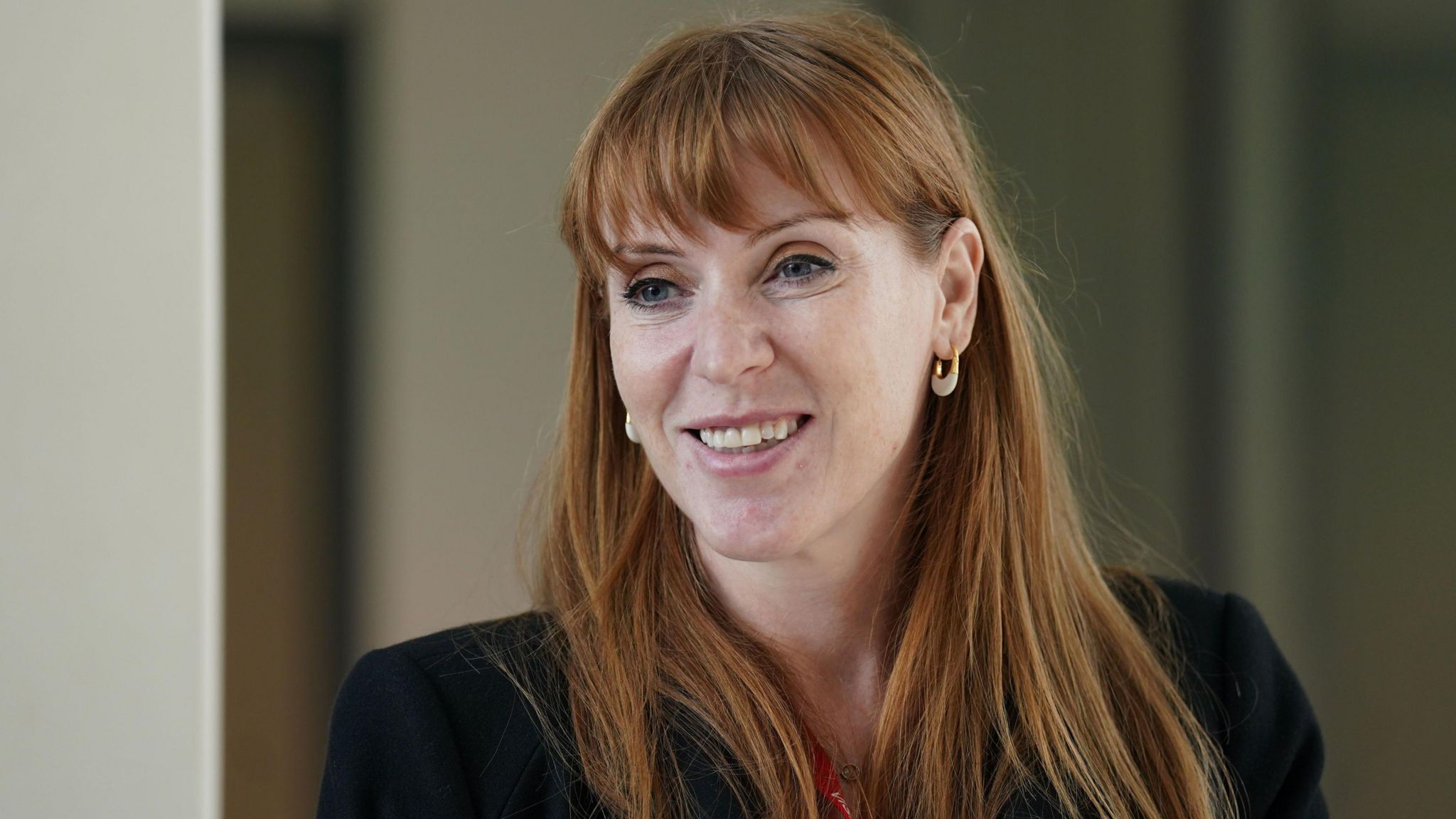 Angela Rayner talking to members of staff during a visit to London Stansted airport