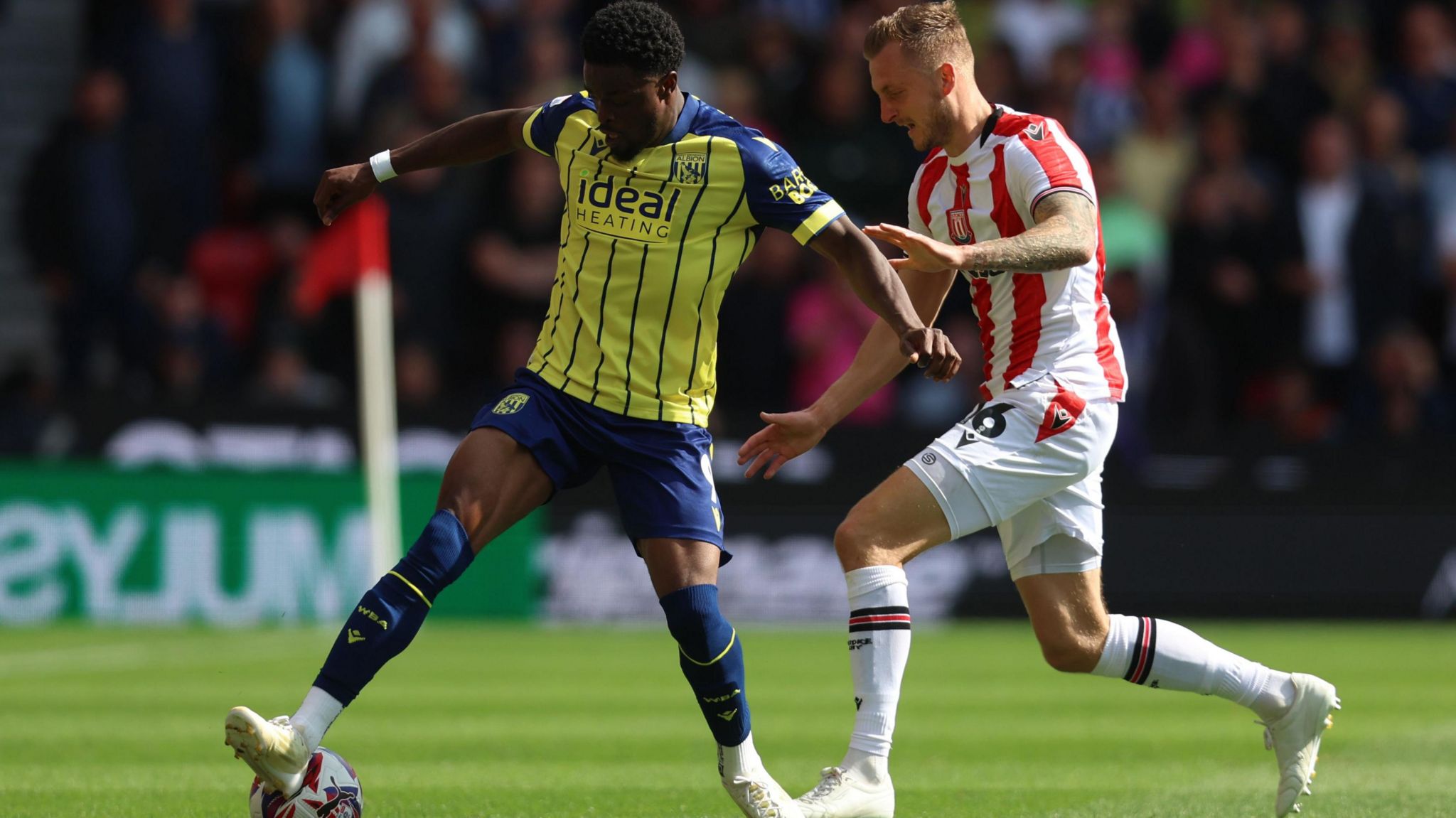 Albion striker Josh Maja attempts to evade Stoke defender Ben Wilmot