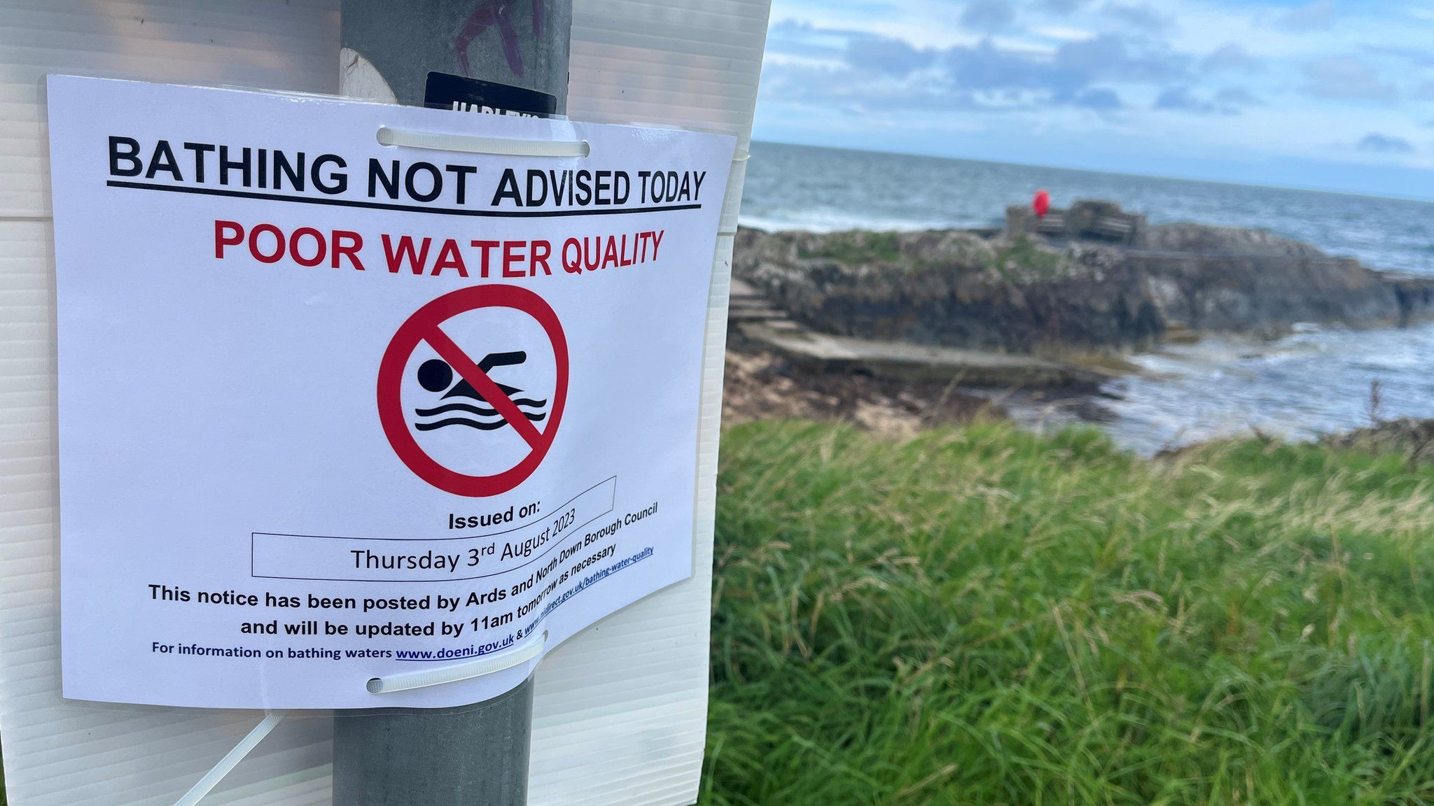 Sign reading 'bathing not advised today - poor water quality'