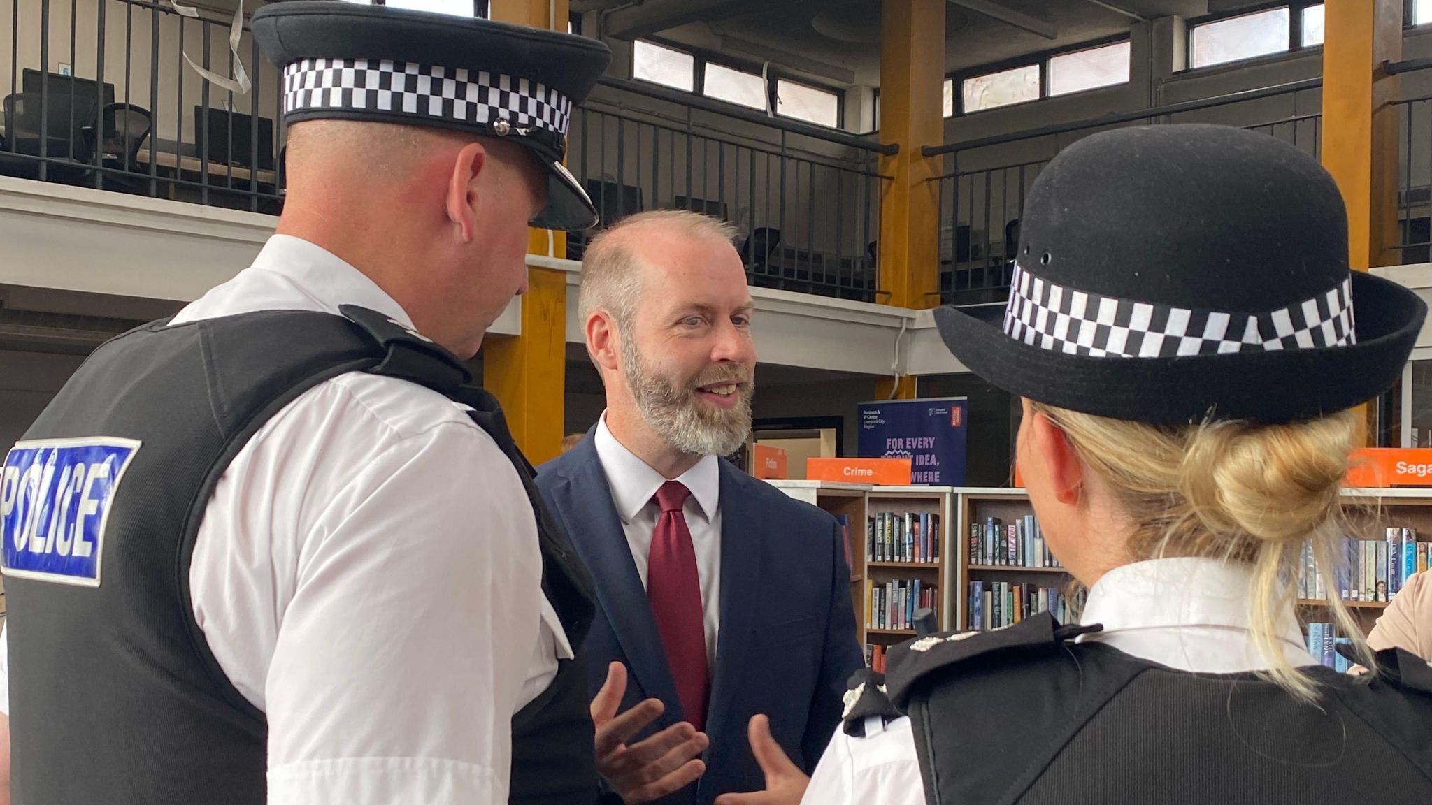 Business Secretary Jonathan Reynolds talking to two police officers