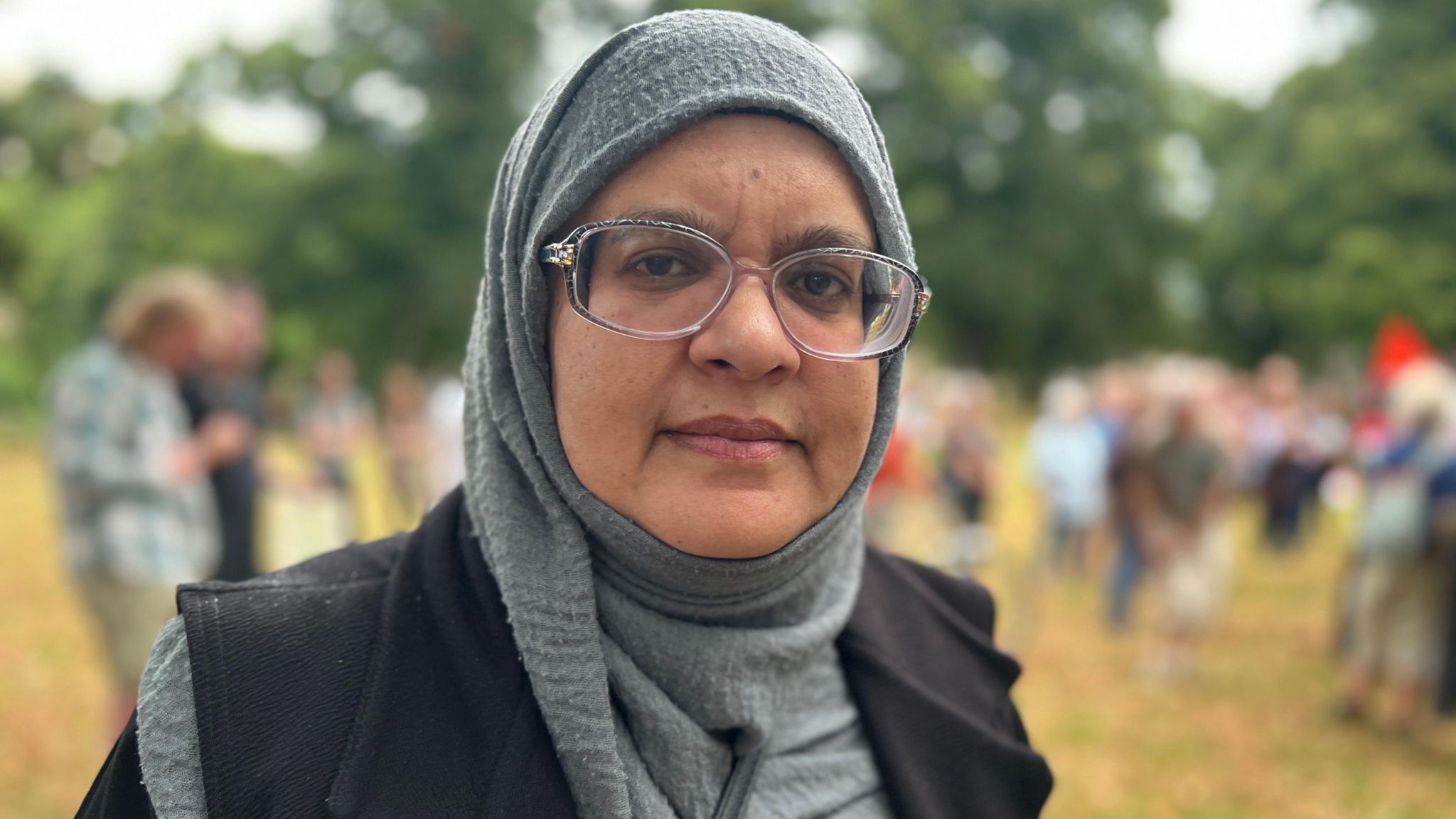 Shahida Rahman in  a black headscarf smiling for camera 