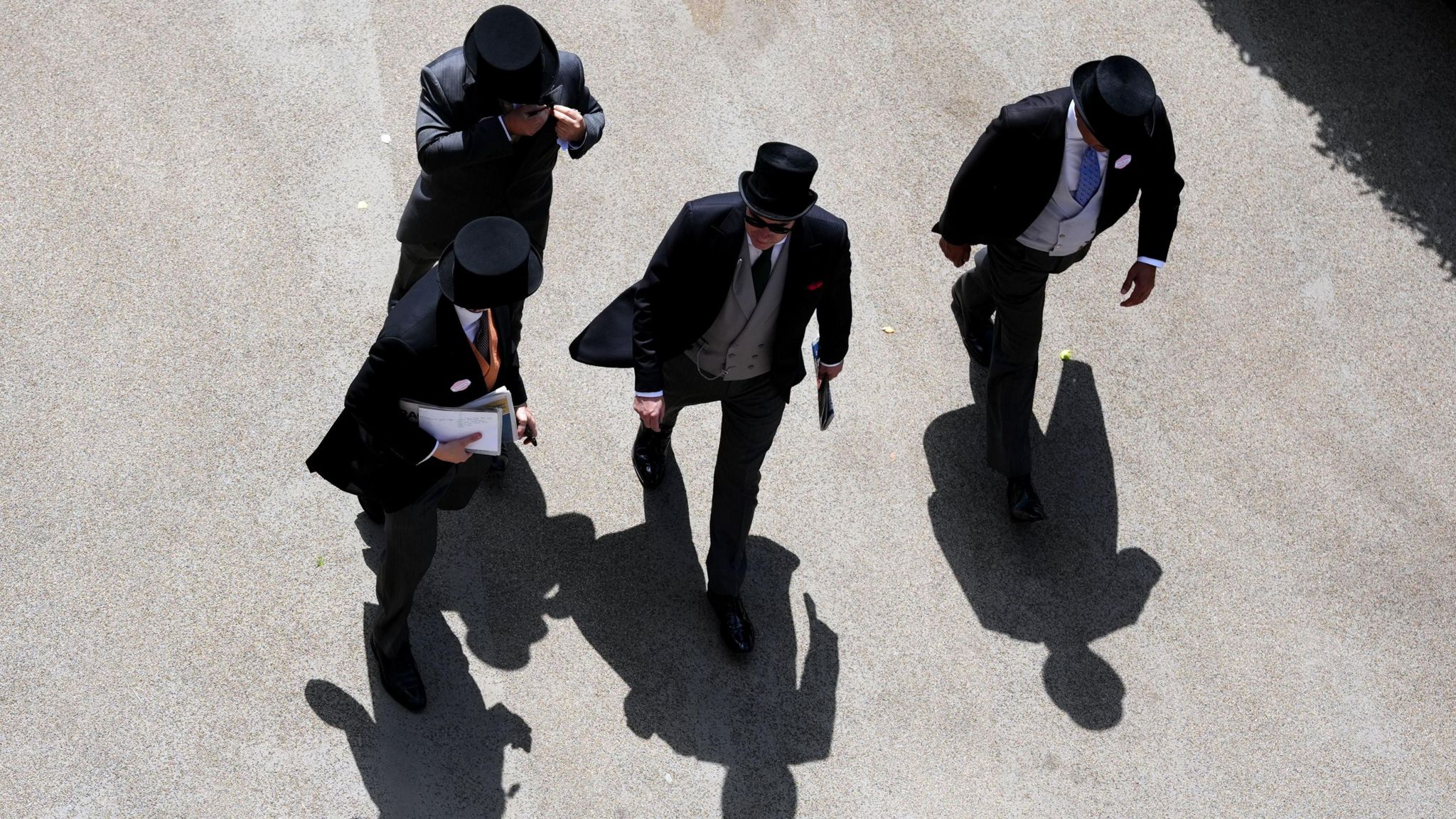 Aerial view of group of four men wearing top hats and tailcoats