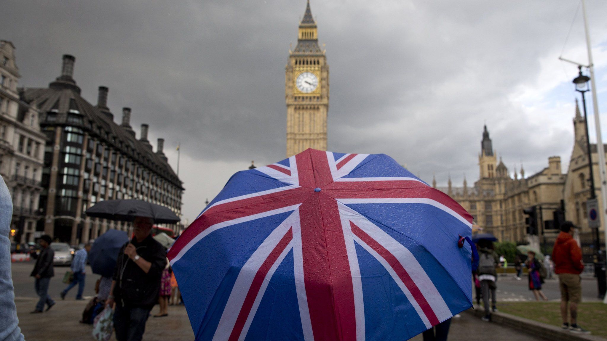 Union flag themed umbrella near Big Ben at the Houses of Parliament in central London on June 25, 2016,