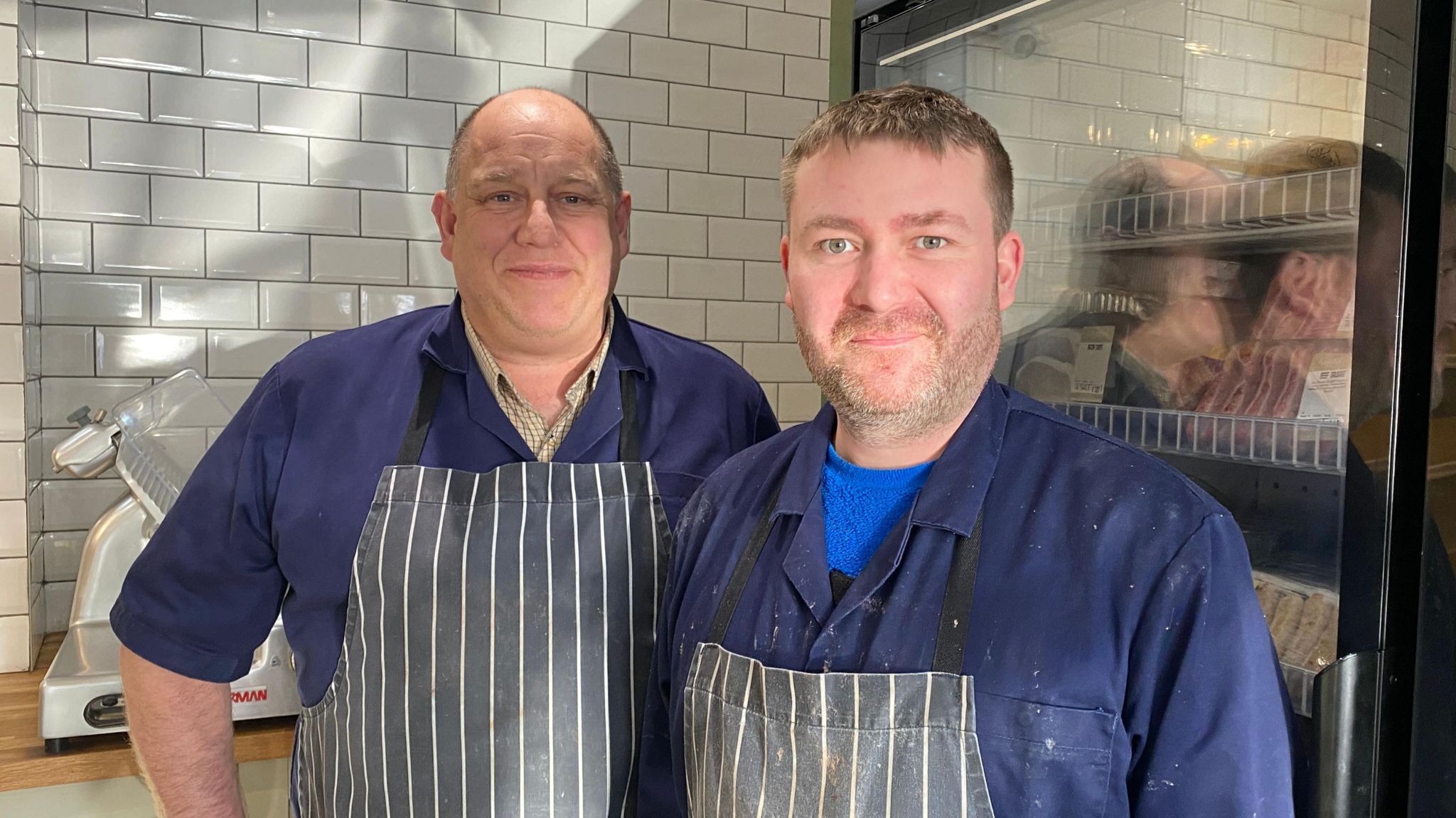 Two butchers standing together, one employer Chris Green, the o ther his apprentice Volodmyr Belei