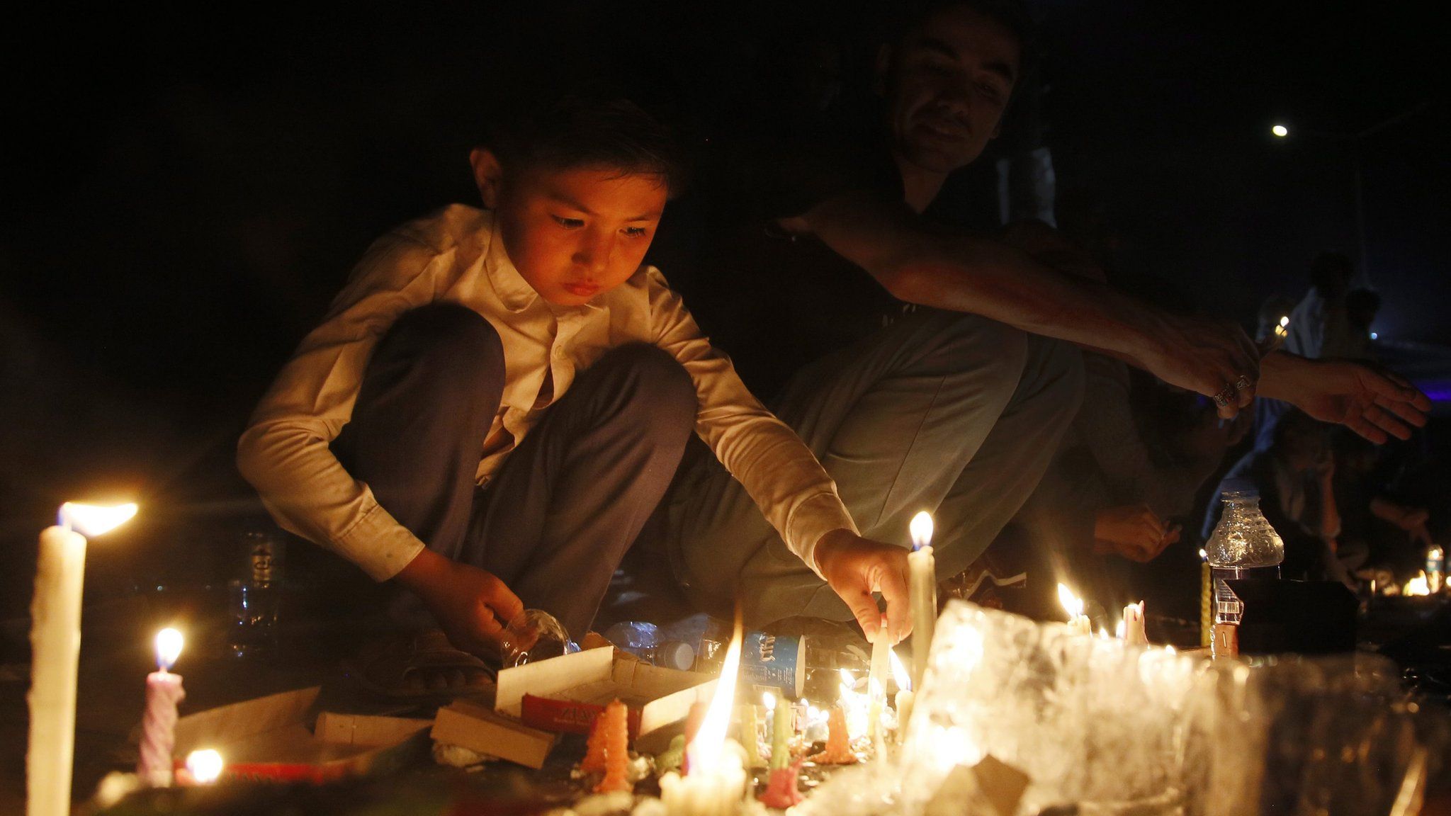 Candles lit during memorial for victims of suicide bomb blast in Kabul. 23 July 2016