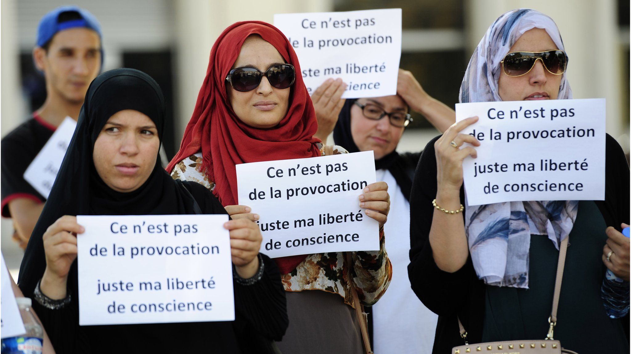 Women in headscarves demonstrating