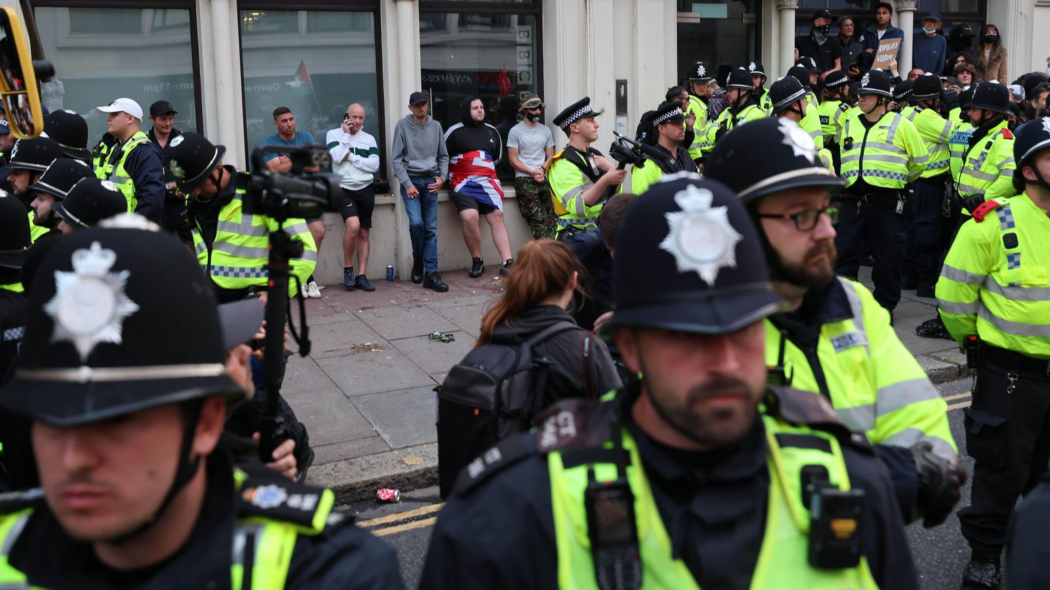 Police form a ring around a small number of anti-immigration protesters