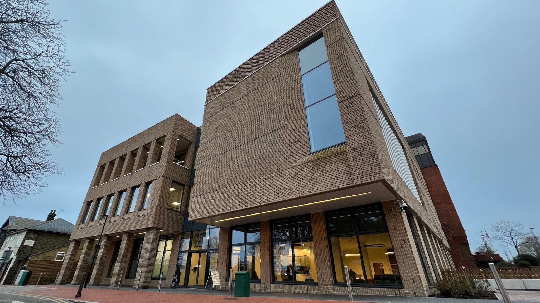 The outside of Thurrock Council, a brown-brick building with glass fronted panelling on the ground floor. 