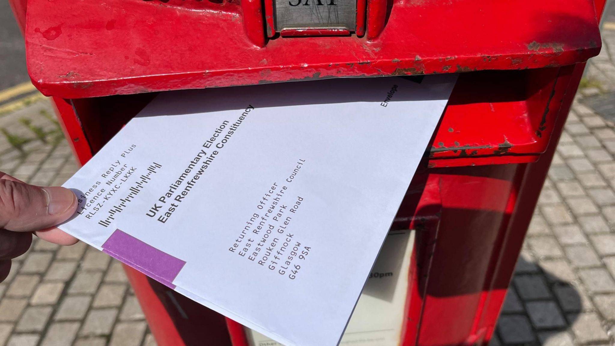 A postal vote being posted