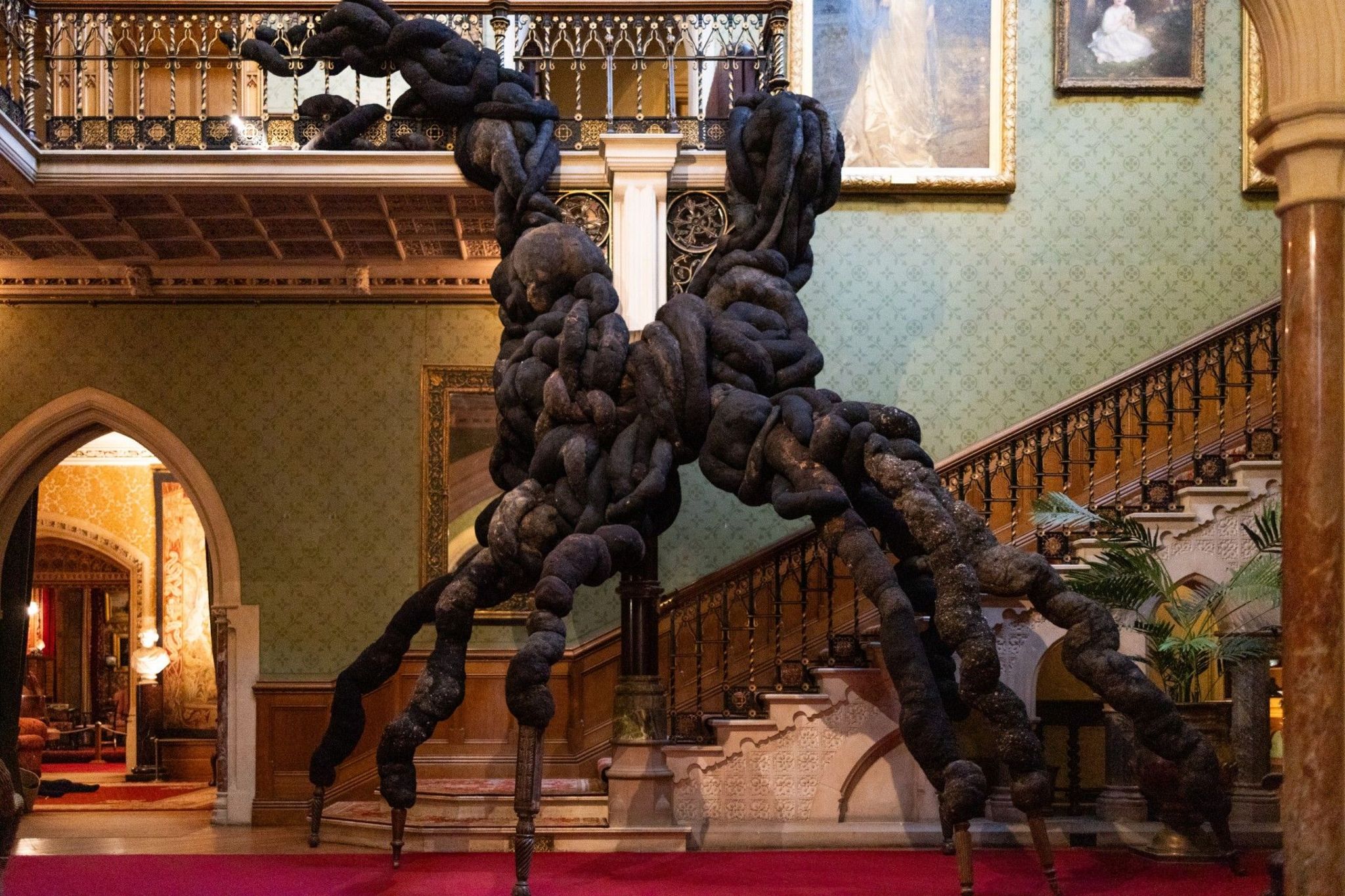 A huge wool installation weaves its way around a grand staircase and bannisters at Tyntesfield House