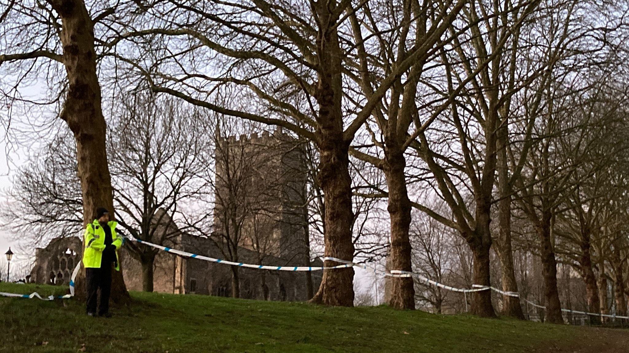 Cordon in place at Castle Park. Police officer and church in shot.