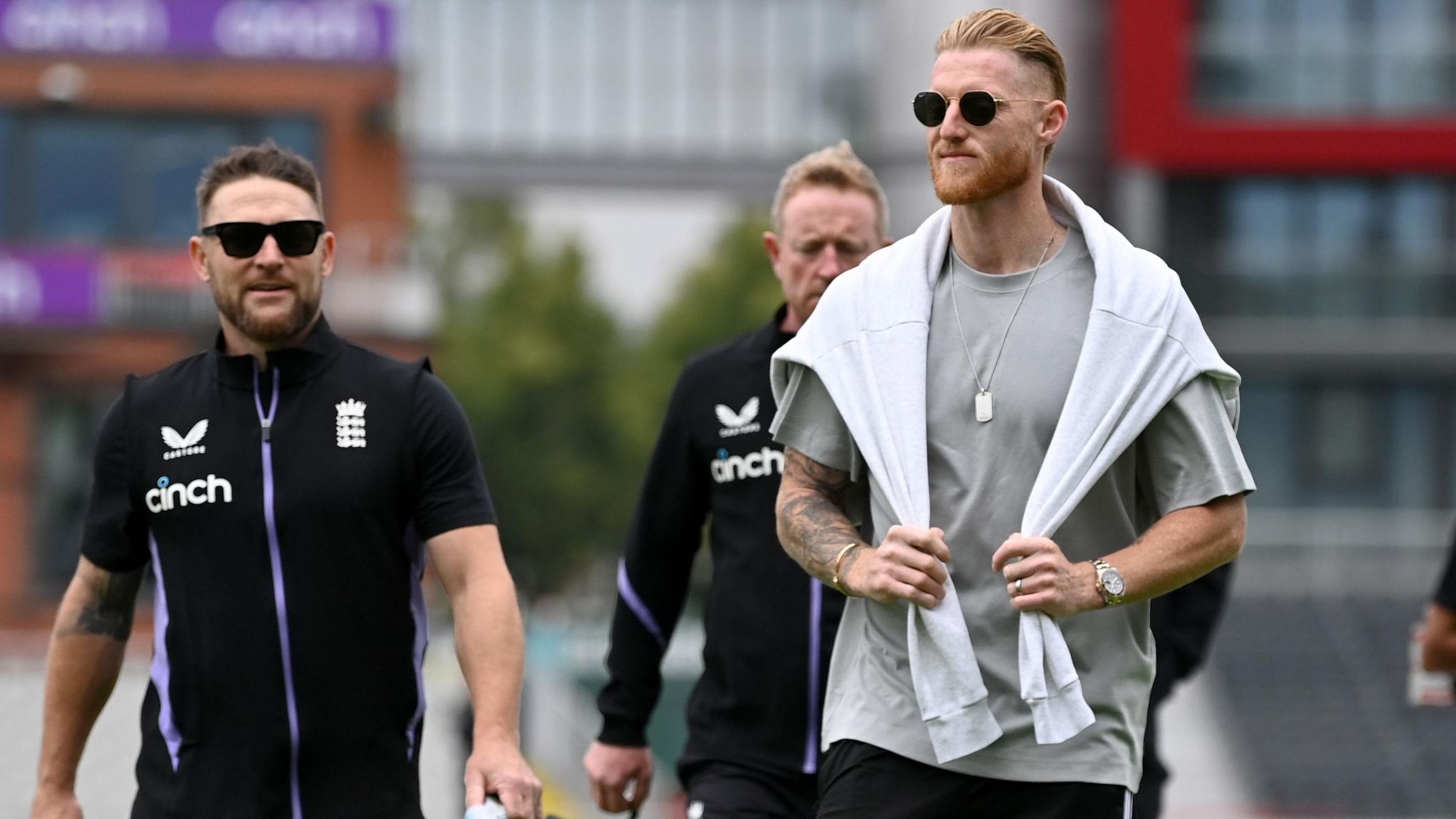 Ben Stokes holds on to the jumper around his shoulders