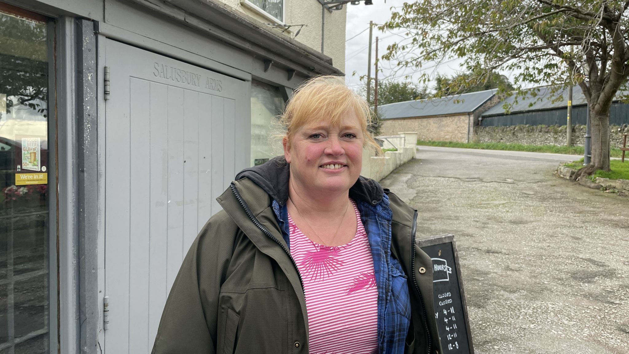Jane Marsh stands outside the grey front door of the Salusbury Arms in Tremeirchian