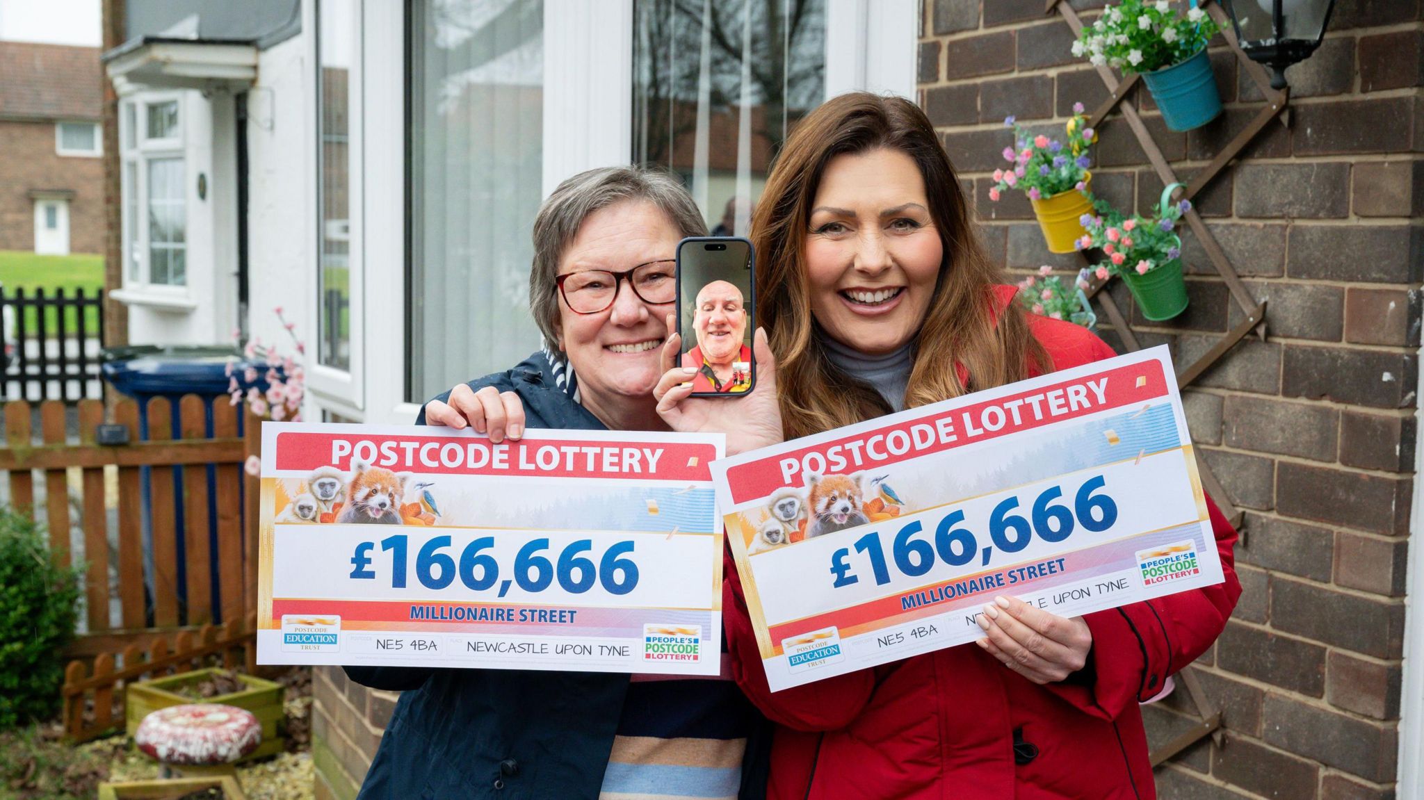 Christine Hedley (left), and husband Tony on a video call, pictured with presenter Judie McCourt, won £166,666 each on the People's Postcode Lottery