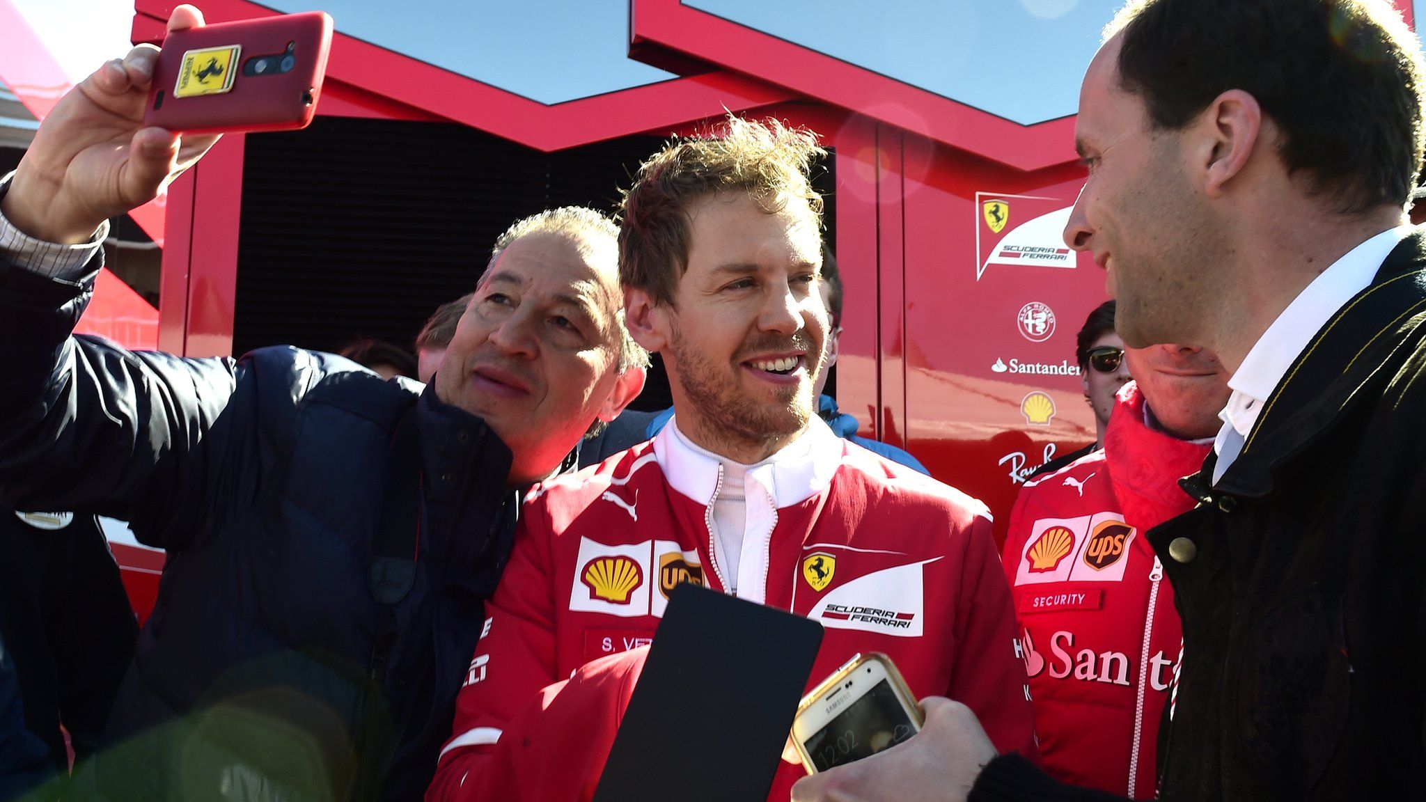 Sebastian Vettel (centre) signs autographs at the Circuit de Catalunya