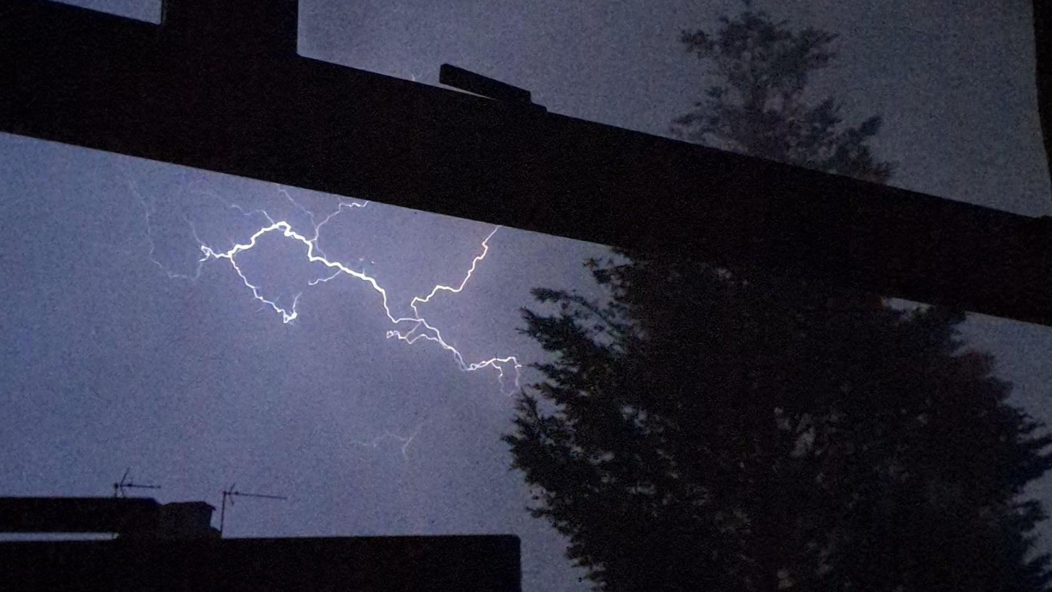 lightning seen from a window at night