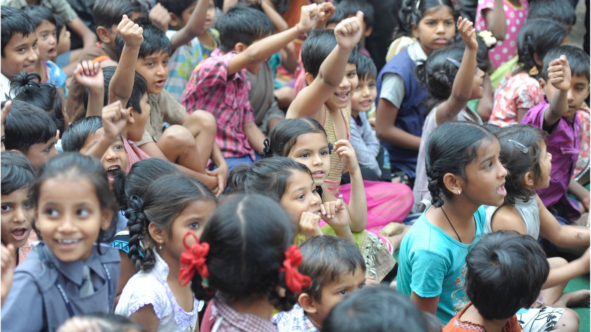 Indian attendees look on during a free book distribution camp held to mark National Girl Child Day at Palamuru Basthi in Hyderabad on January 24, 2017.