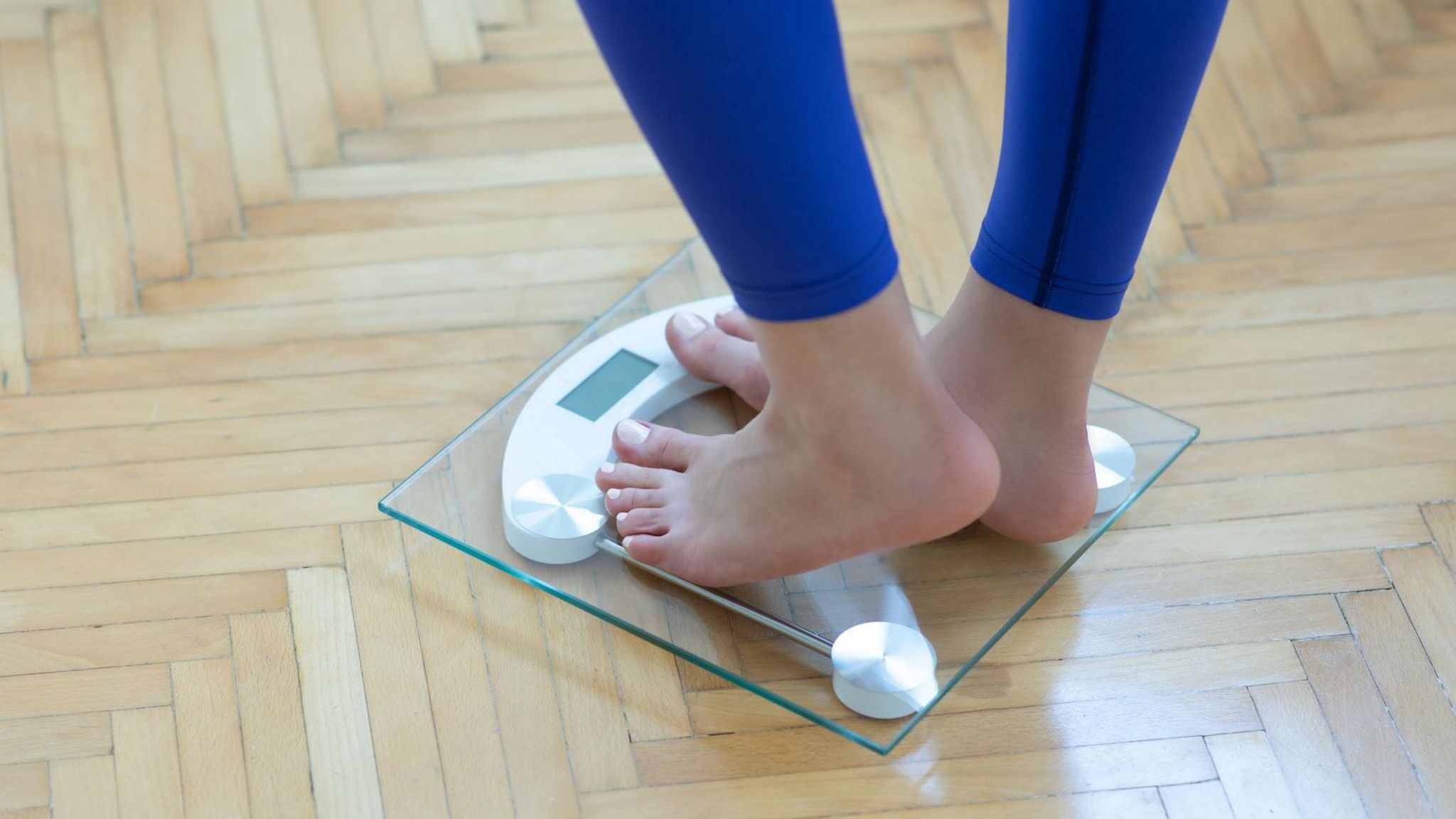 Woman weighing herself