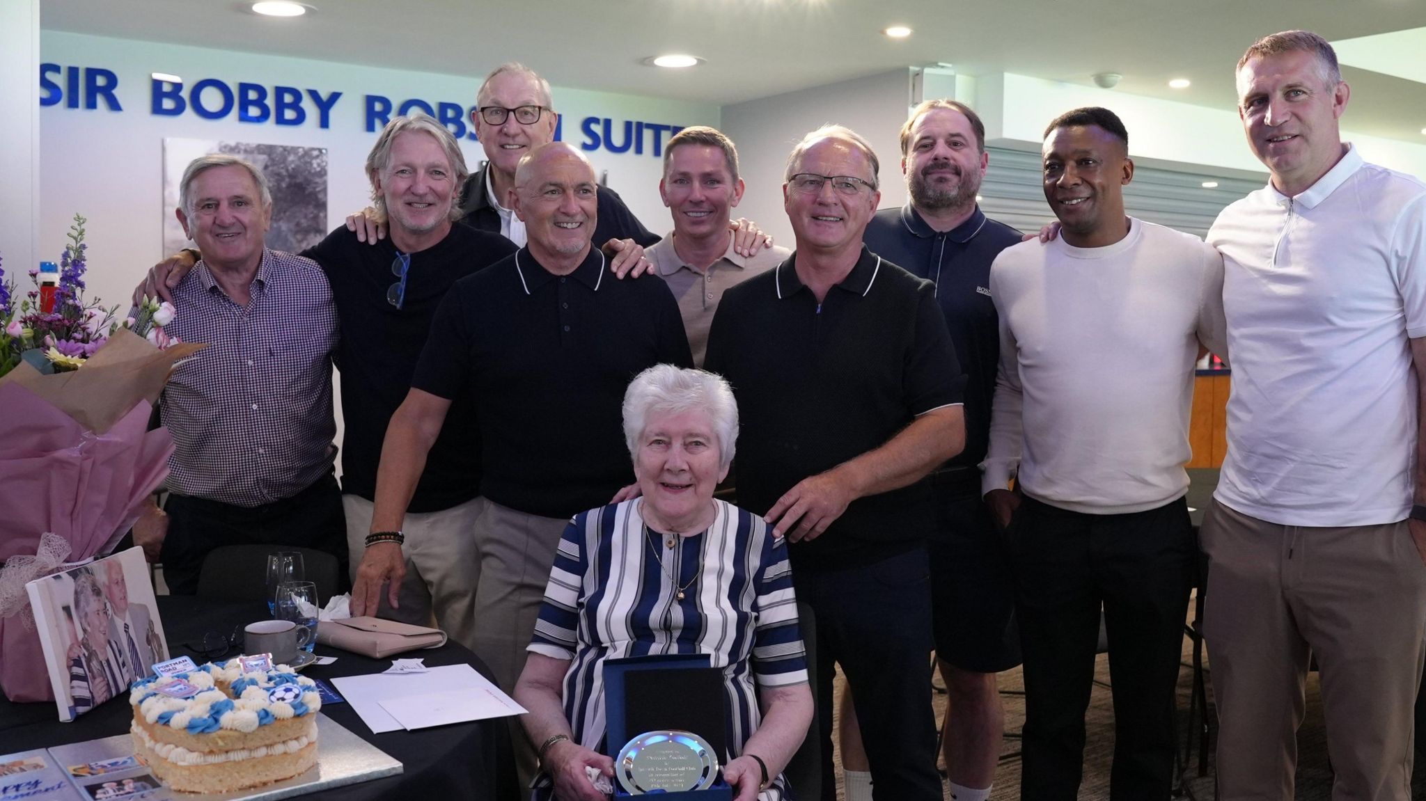 Pat Godbold sat down surrounded by former Ipswich Town footballers