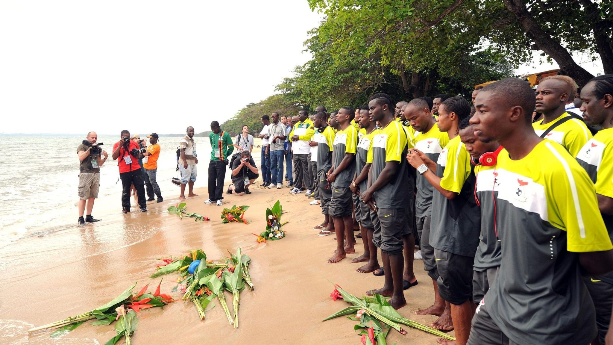 Namibia's players line up on the beach and lay flowers in the surf in honour of their 1993 counterparts