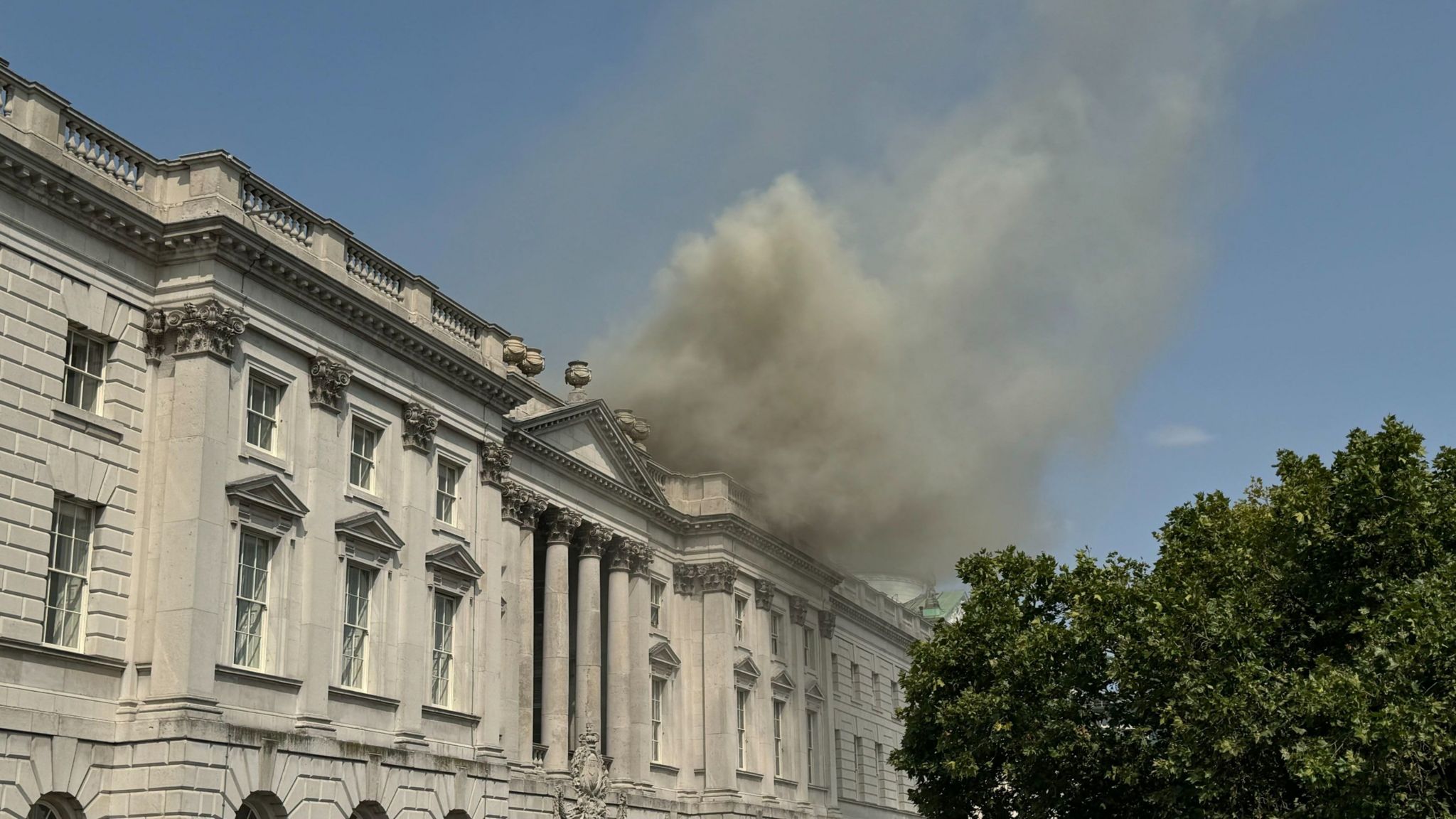 Smoke billowing out of the roof of Somerset House in central London