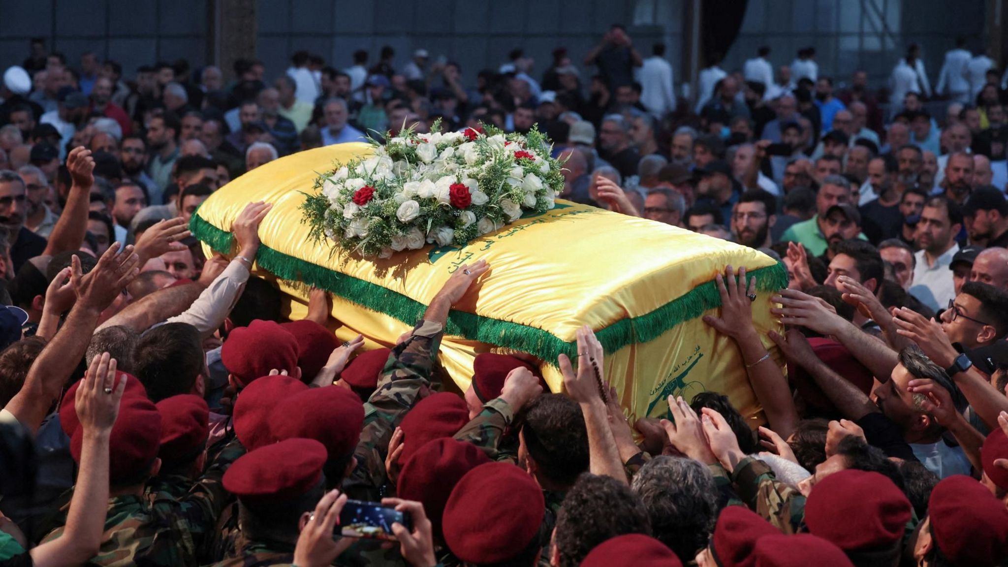 Members of Hezbollah carry the coffin of Mohammed Nasser, a senior Hezbollah commander killed in an Israeli air strike, in Beirut, Lebanon (4 July 2024)