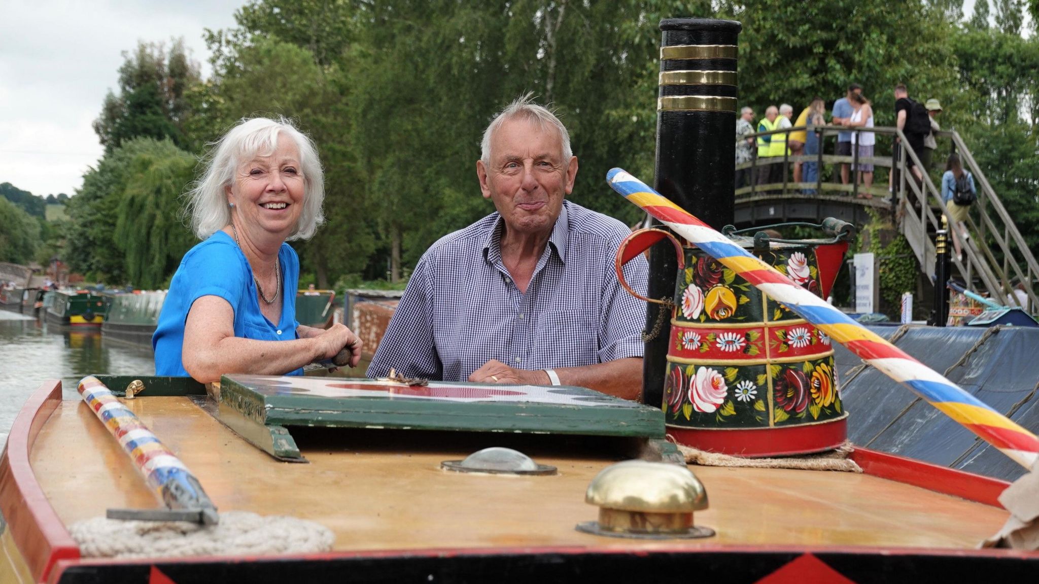 Lady Sheila with light-coloured hair aboard a narrowboat with the owner