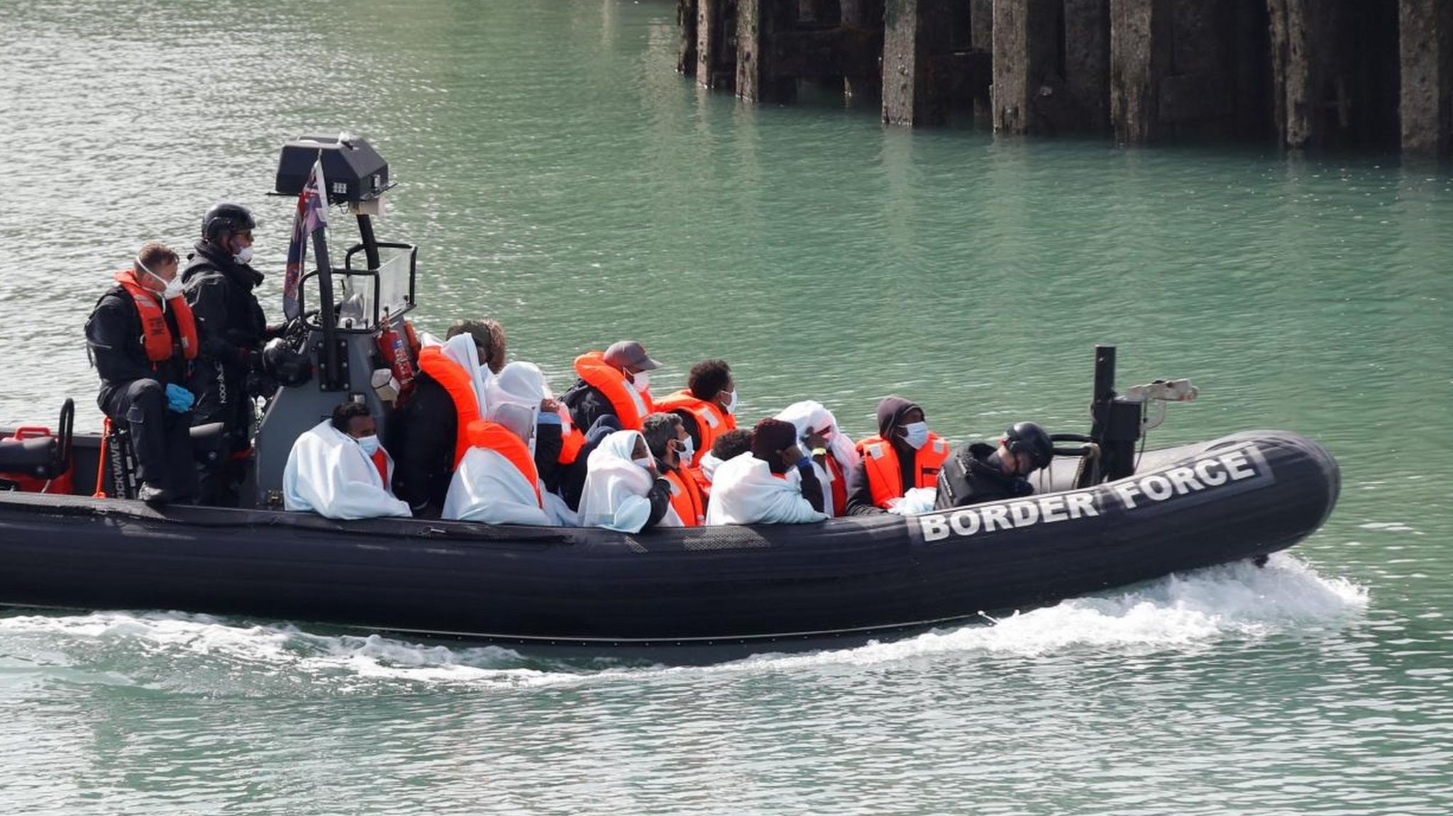 Border Patrol agents bring migrants into Dover harbour 7 September 2020