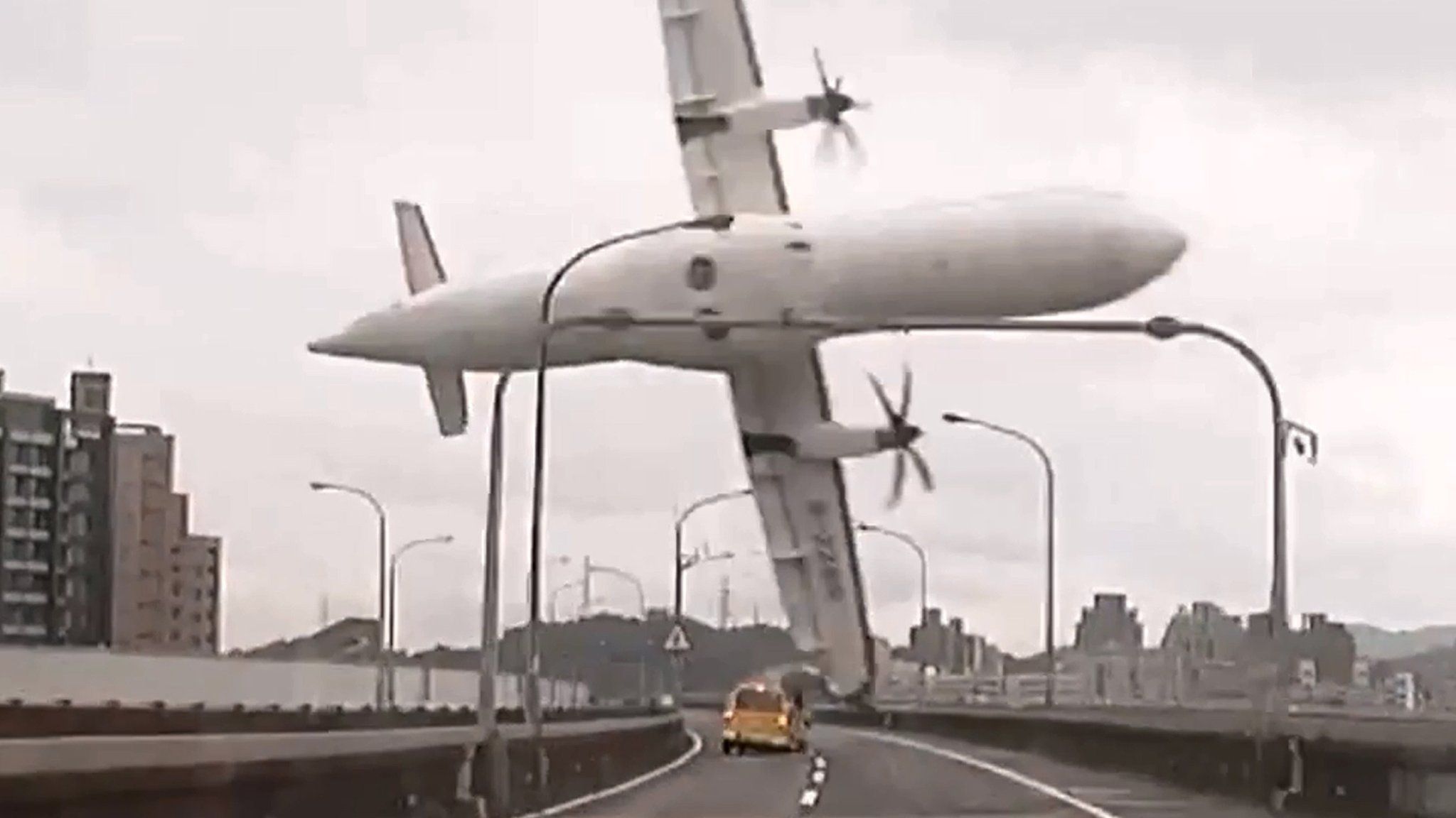 File photo: This screen grab taken from video provided courtesy of TVBS Taiwan on 4 February 2015 shows a TransAsia ATR 72-600 turboprop plane clipping an elevated motorway and hitting a taxi (centre) before crashing into the Keelung river outside Taiwan's capital Taipei in New Taipei City