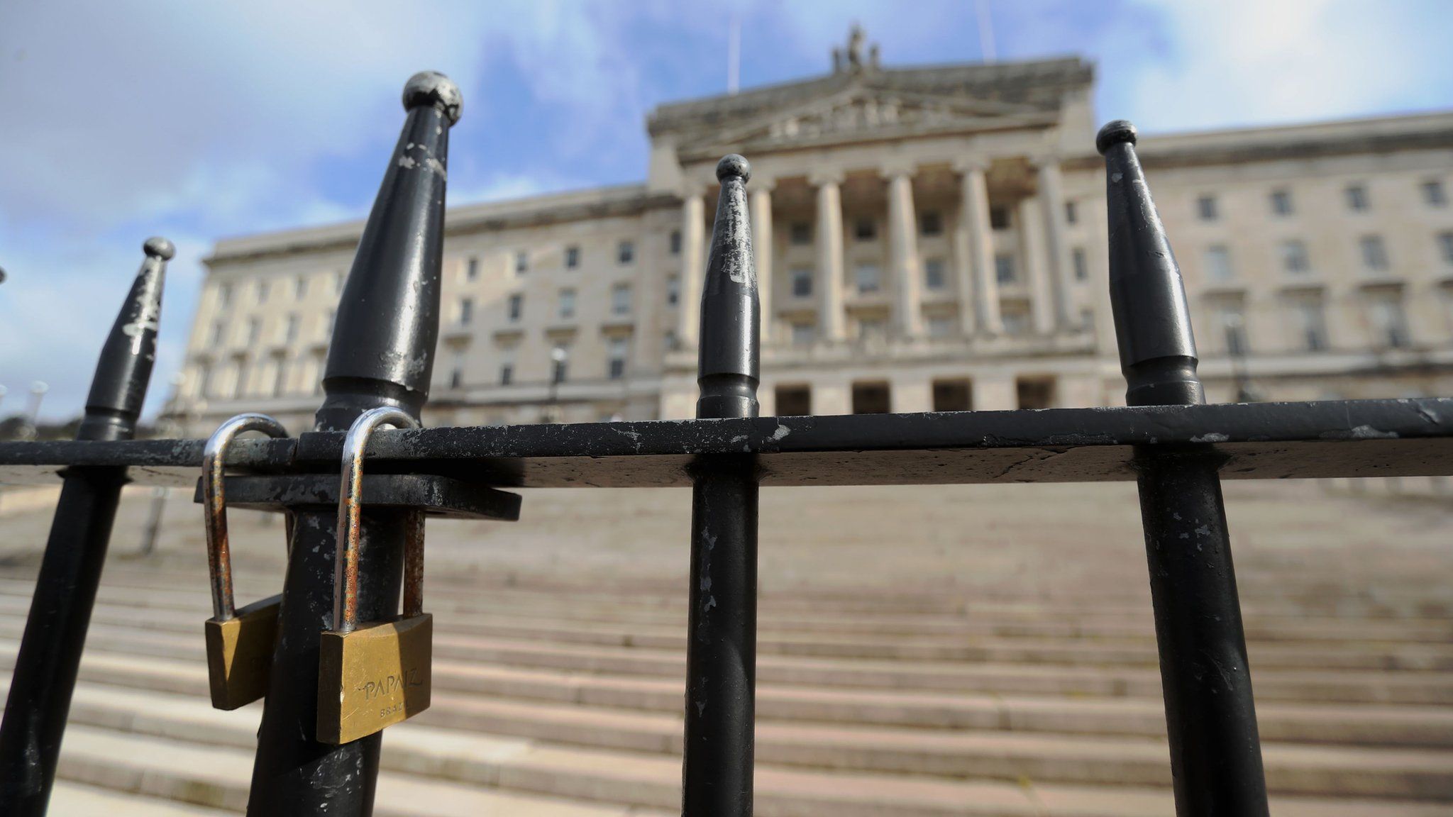 Parliament Buildings in the Stormont estate in Belfast, seen behind a locked gate