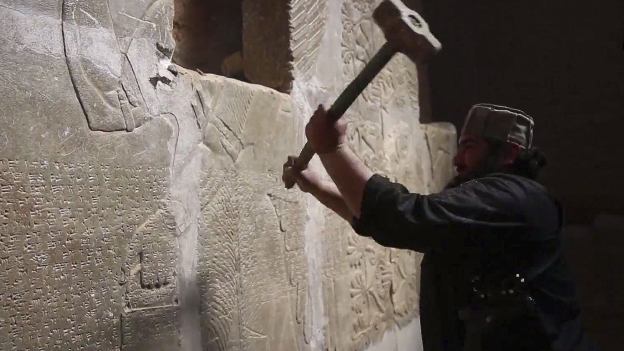 IS image from April 2015 reportedly showing militant taking a sledgehammer to an Assyrian relief