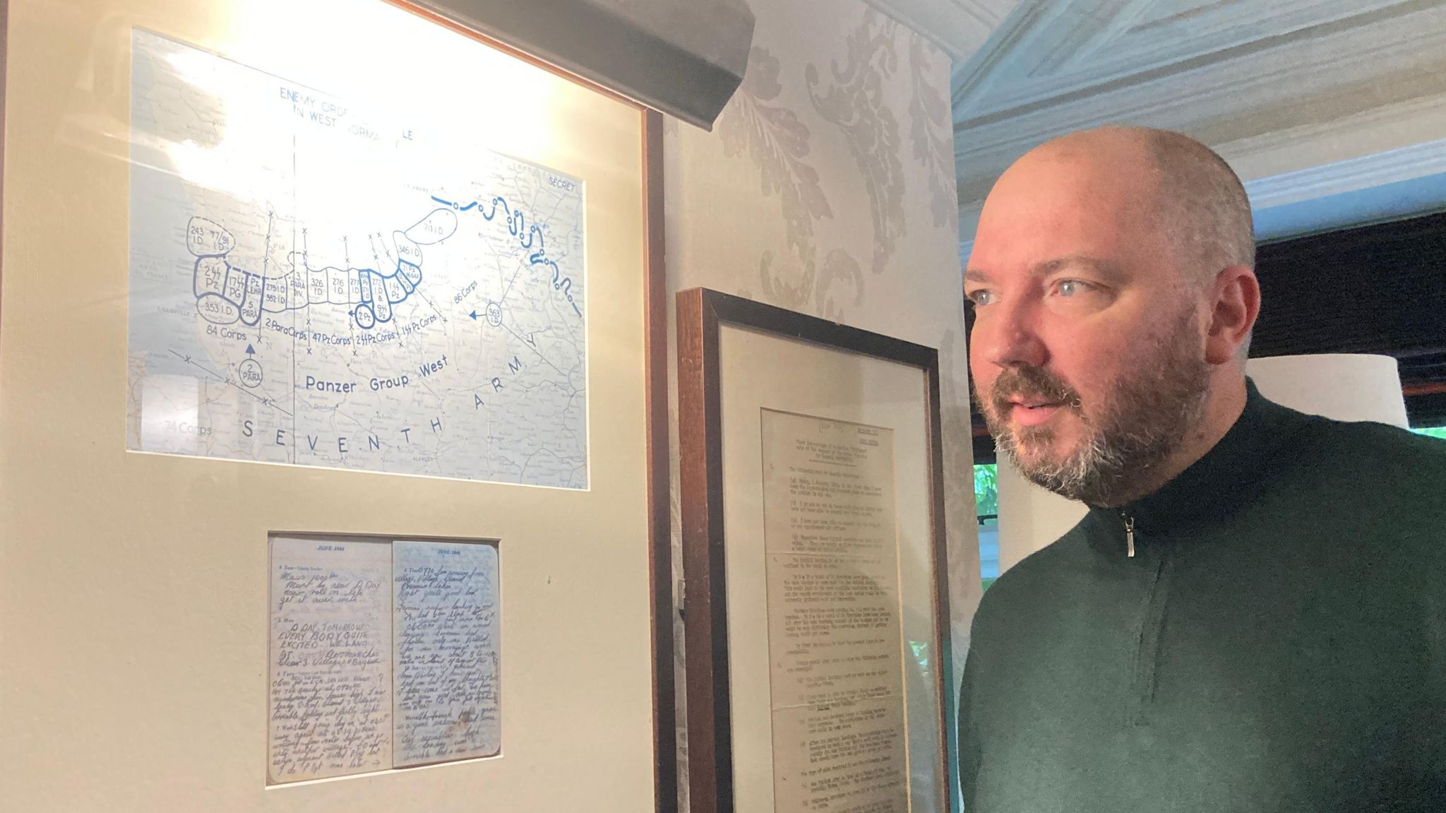 Bells of Peover landlord Phil Smith inspects a D-Day map