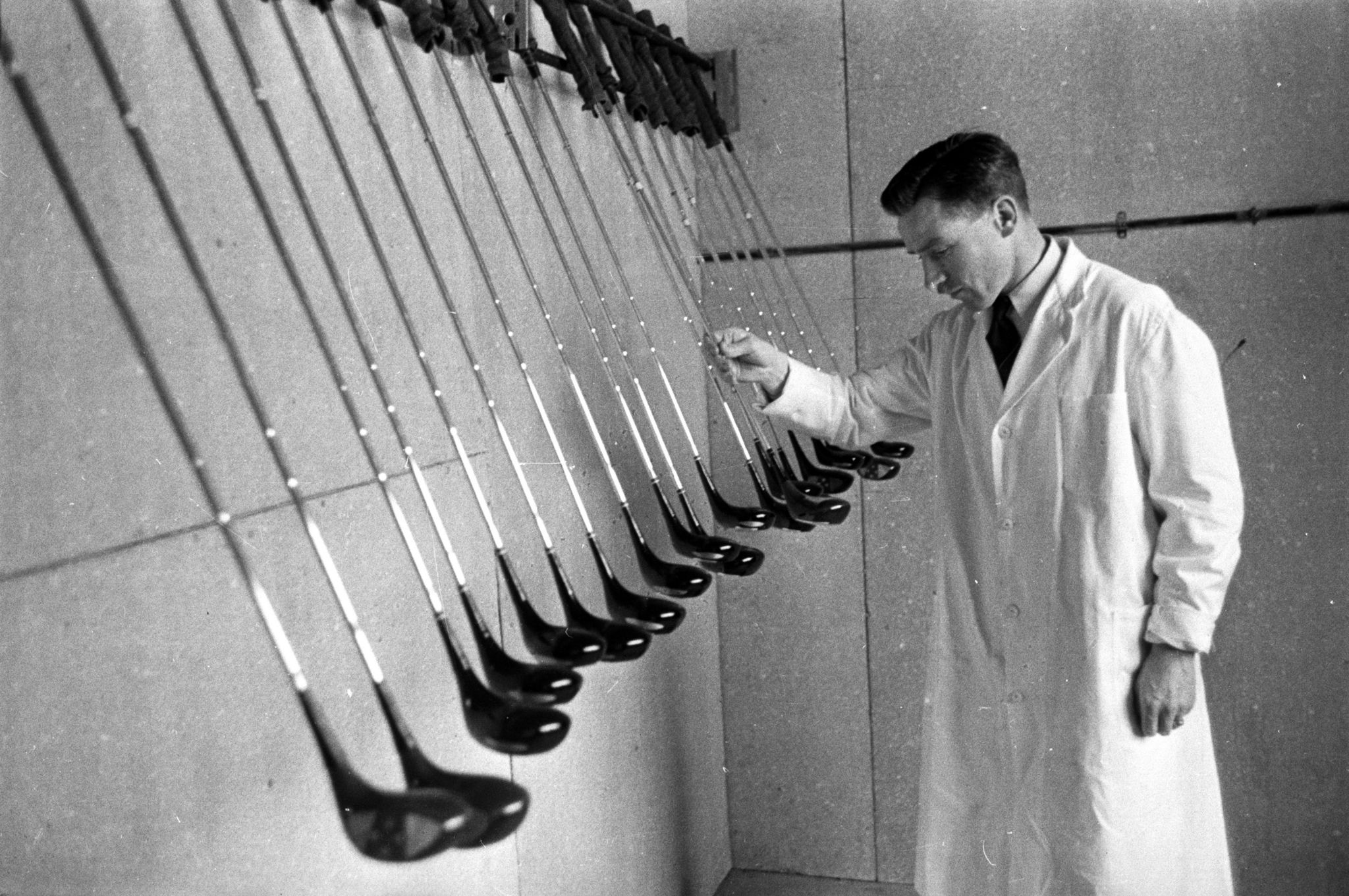 20th August 1955: A line of golf clubs undergoing inspection at the John Letters and Co. factory on Hillington Industrial Estate, Glasgow. The factory produces around 6,000 golf clubs a month and increased demand has lead to a doubling of production in a year. The clubs are sold in Scotland, where the sport is very popular, and also exported around the world. Original Publication: Picture Post - 7942 - Let Glasgow Flourish! - pub. 1955 (Photo by Haywood Magee/Picture Post/Hulton Archive/Getty Images)