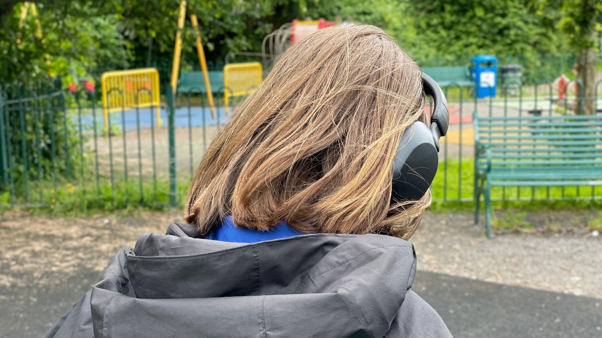 Child from the back weating headphones