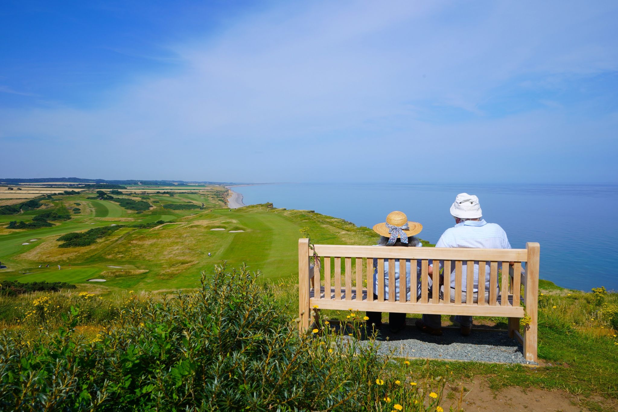 A couple on a bench overlooking the sea