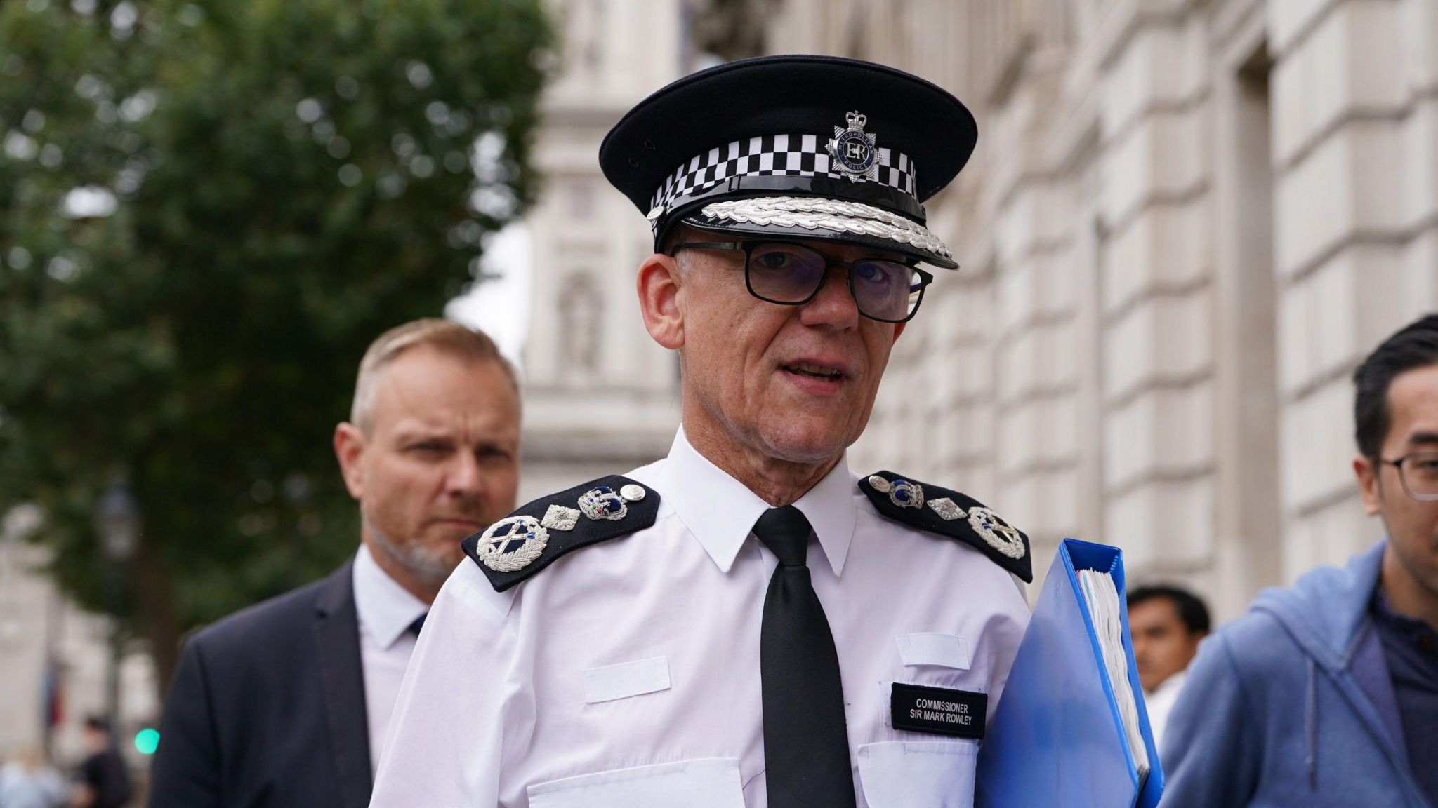 File image showing Sir Mark Rowley wearing a hat and uniform while carrying a blue folder