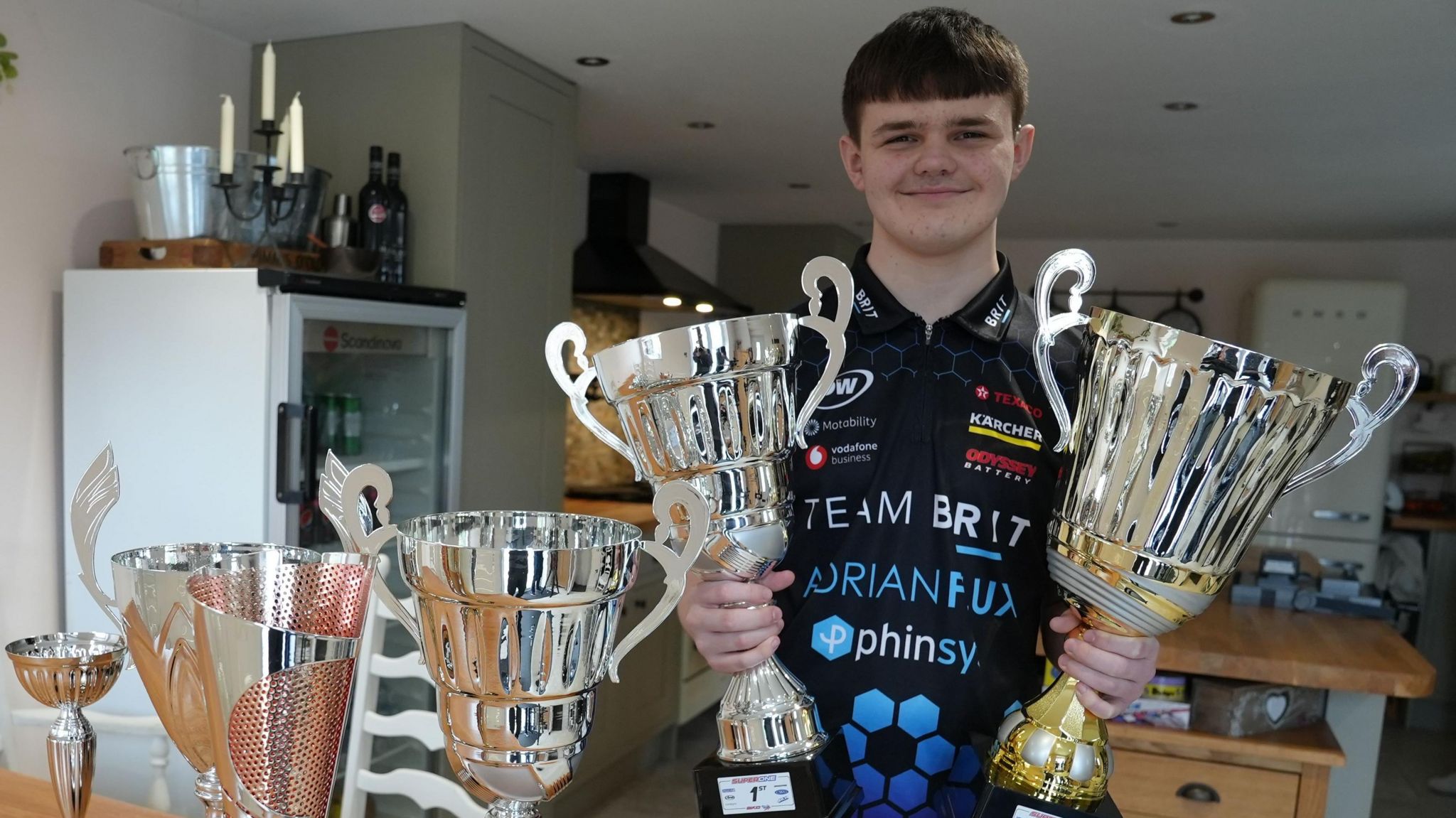 Caleb with his racing trophies