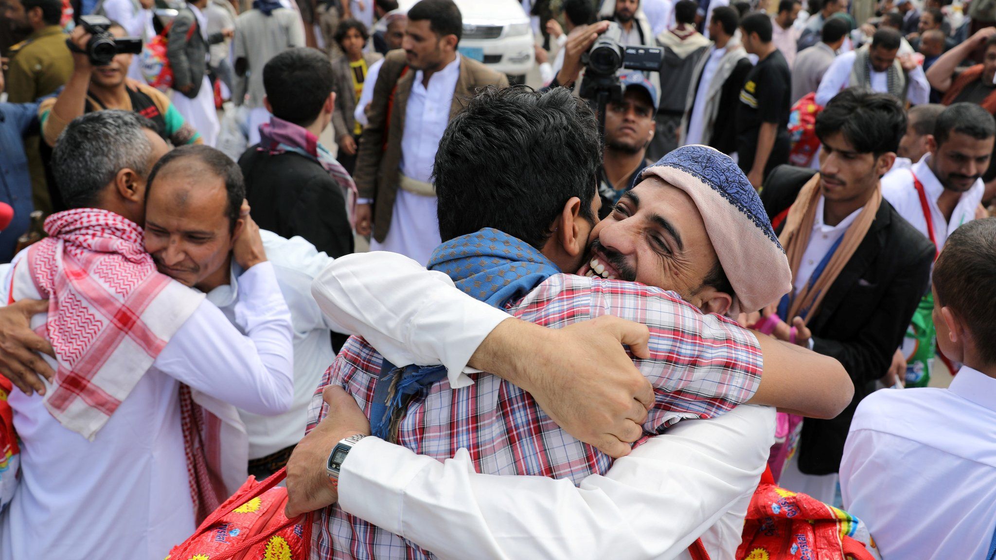 Yemeni detainees hug relatives after being released by the rebel Houthi movement in Sanaa (30 September 2019)
