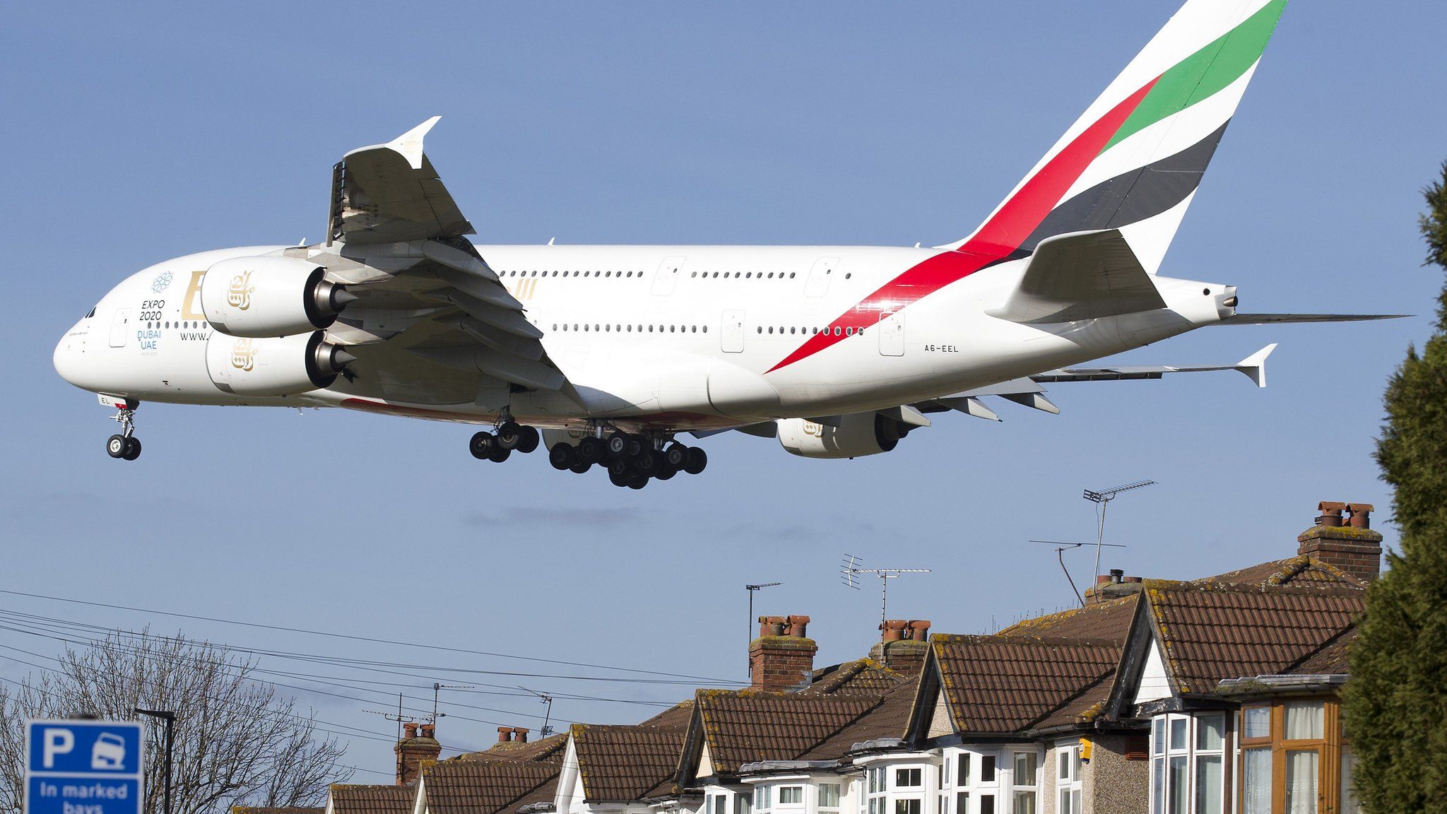An Emirates Airbus A380 preparing to land at Heathrow Airport flies over houses in west London