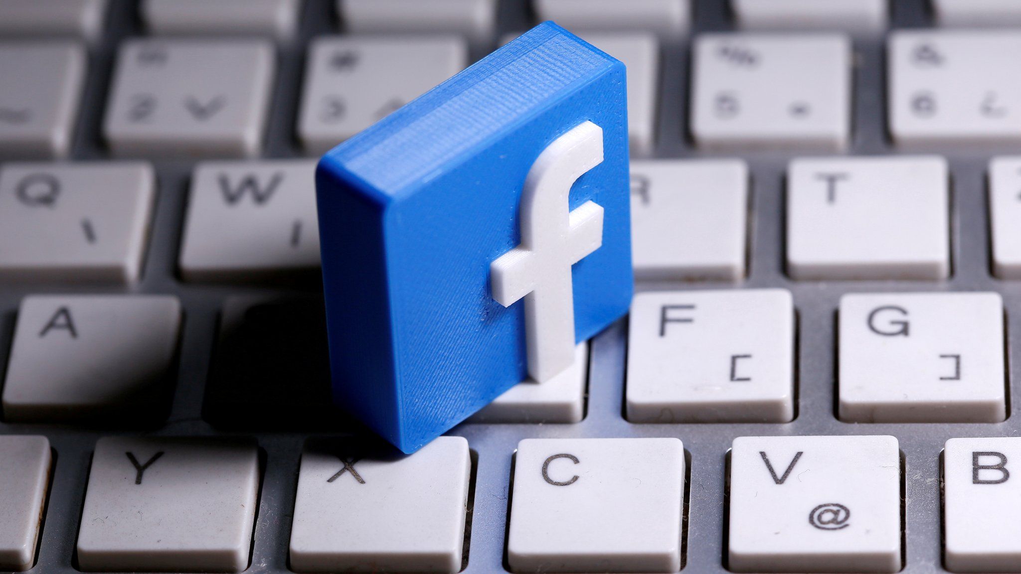 3D-printed Facebook logo is seen placed on a keyboard in this illustration taken March 25, 2020.