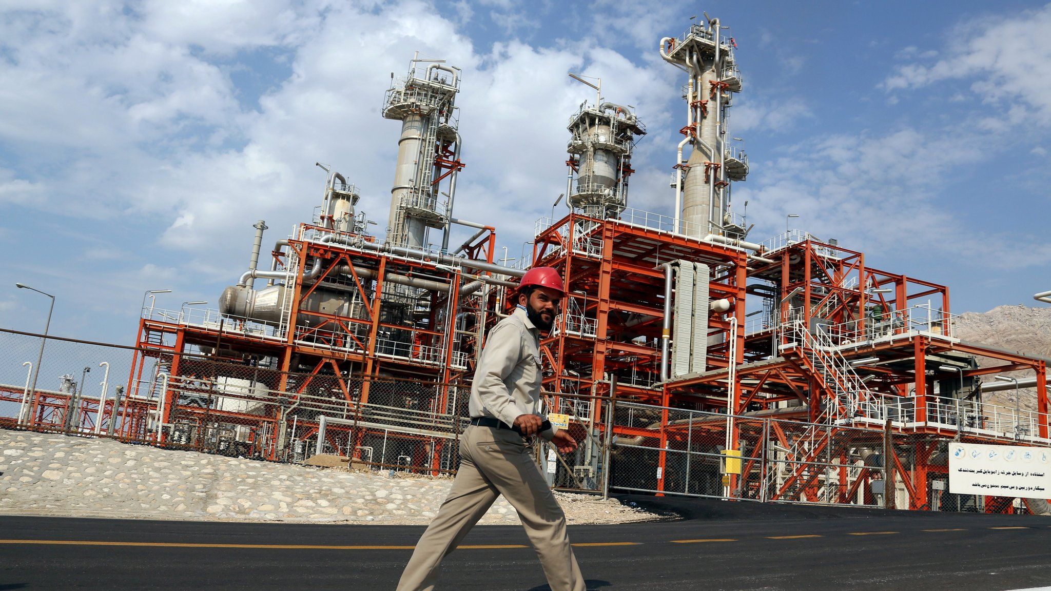 An Iranian employee walks at the phase 15-16 of the South Pars gas field facilities in the southern Iranian port town of Assaluyeh on the shore of the Gulf on November 19, 2015.