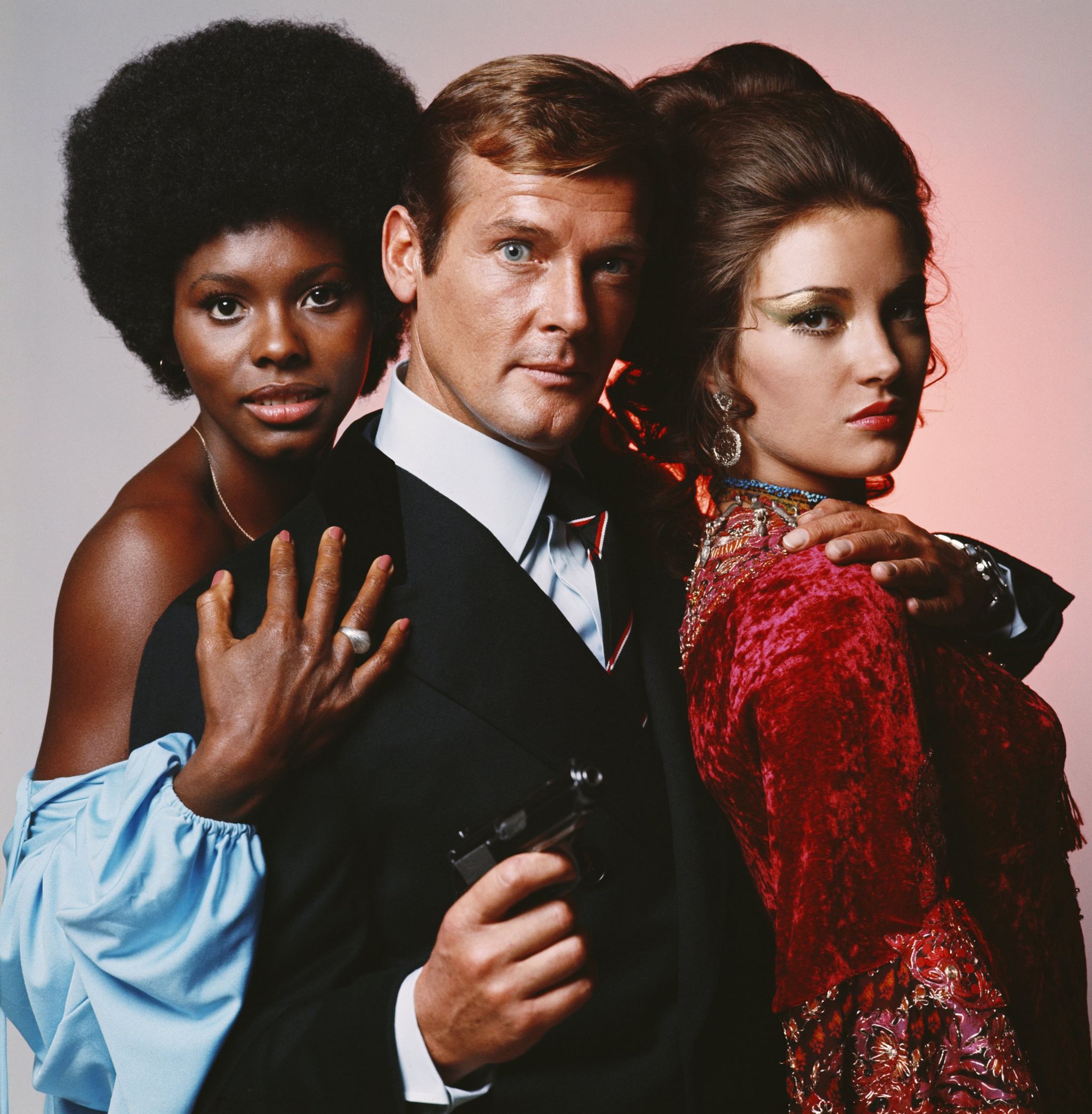 Actor Roger Moore as James Bond with Live and Let Die co-stars Gloria Hendry (left) and Jane Seymour in 1973