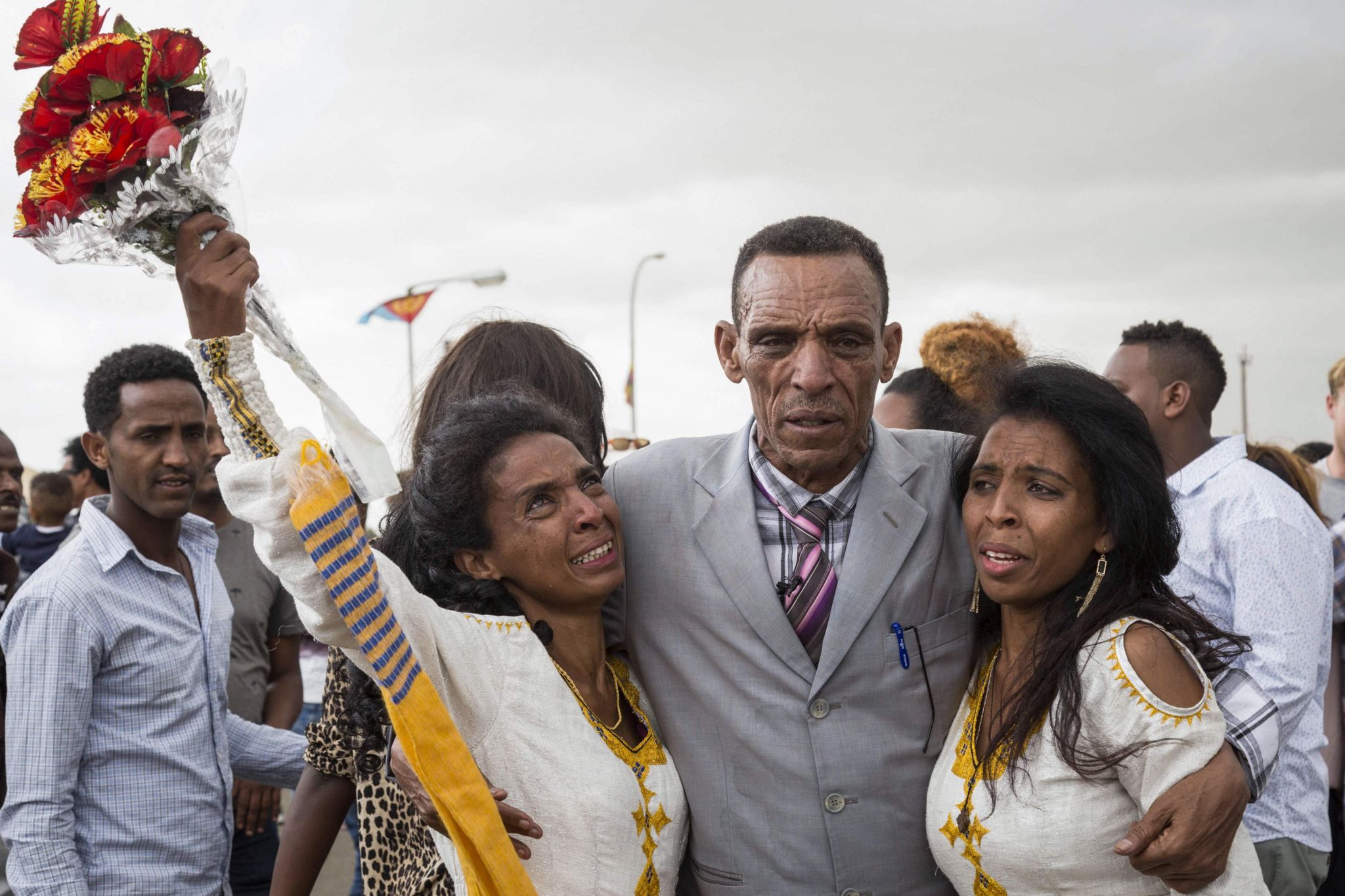 Azmera Addisalem and Danait Addisalem get emotional as they see again their father (who is an Ethiopian journalist) for the first time in 20 years, upon his arrival at the Asmara International airport, on July 18, 2018.