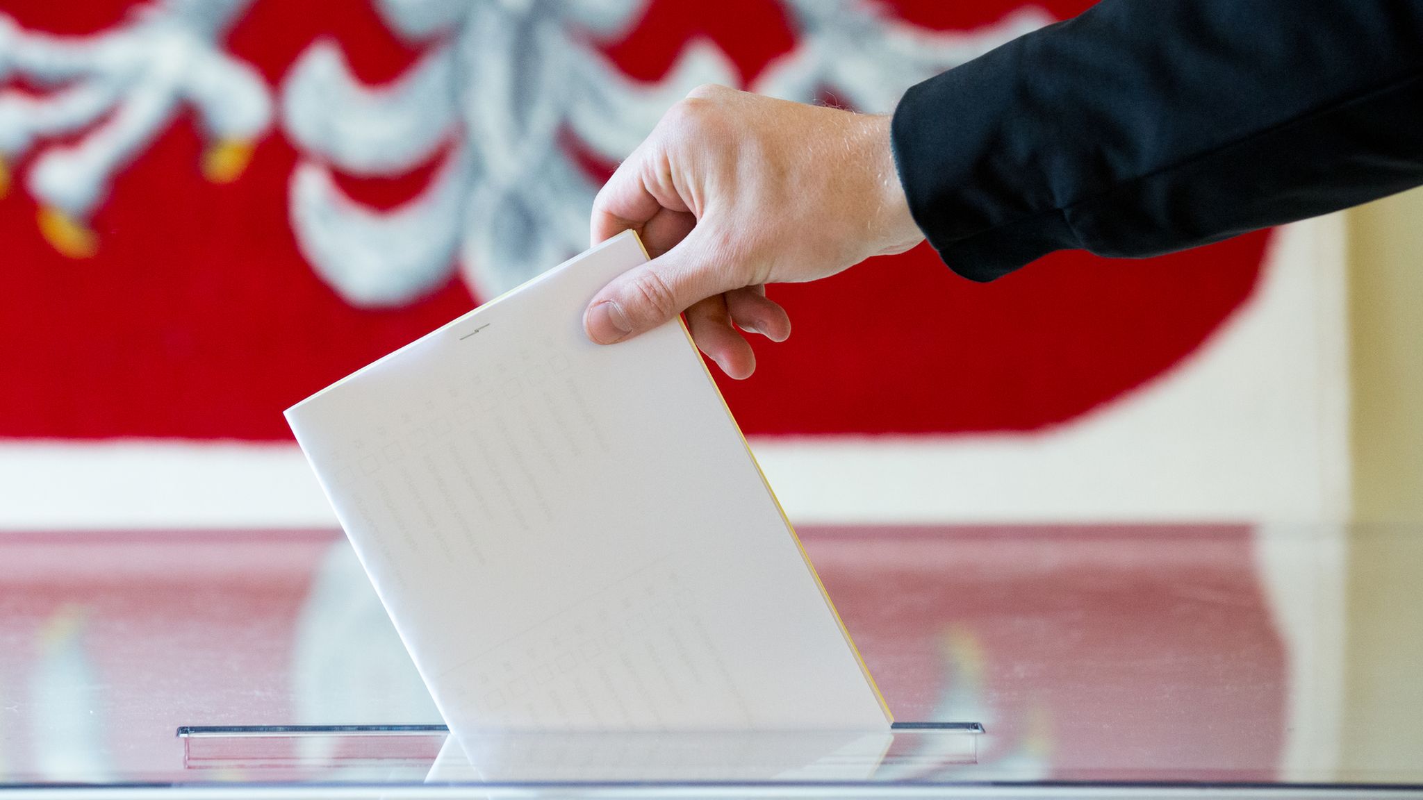 Voting slip being placed in ballot box at a polling station in Poland