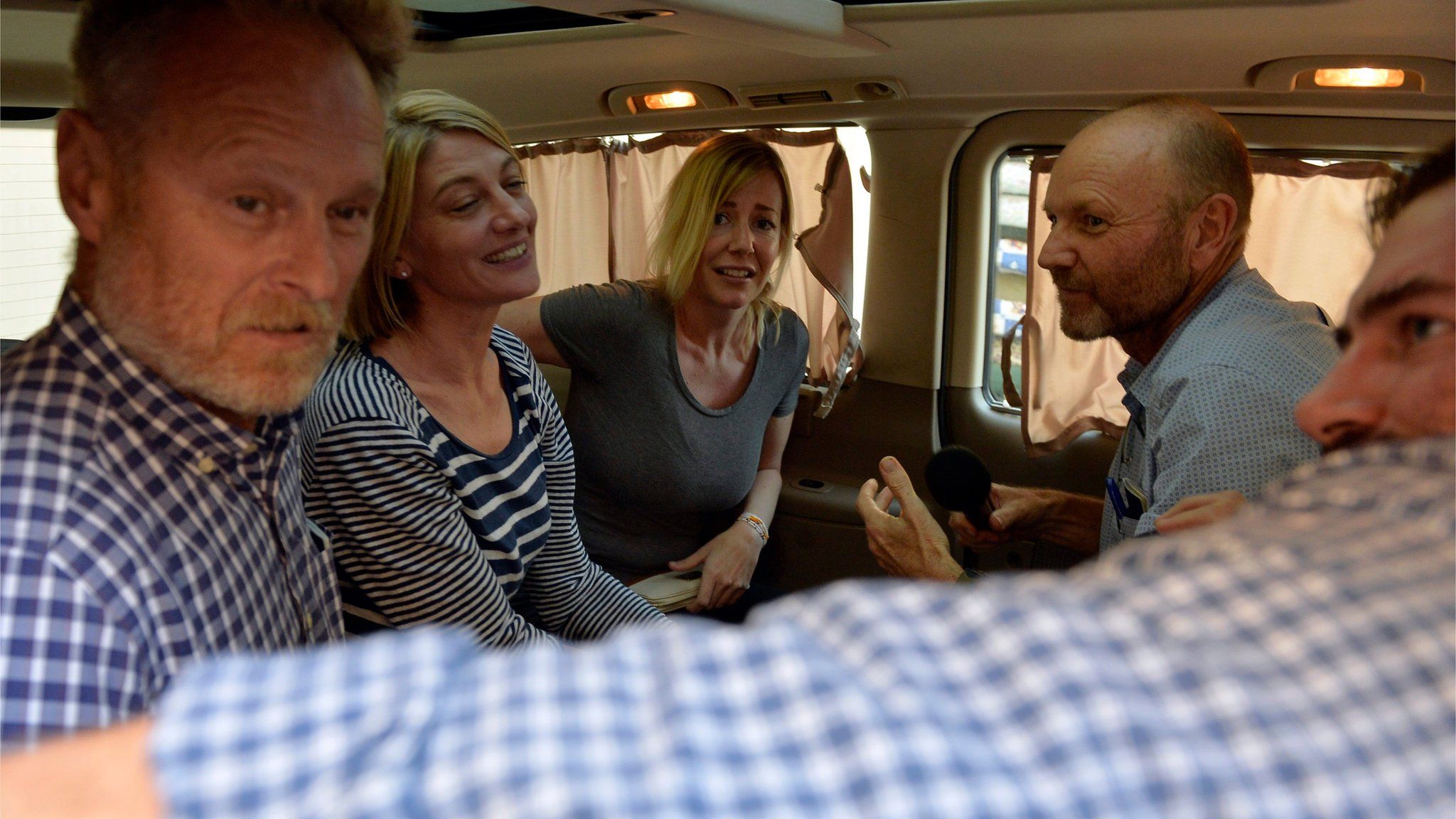 Members of Australian Channel Nine TV crew and Sally Faulkner (centre) sit inside a minivan after their release on bail in Lebanon (20 April 2016)
