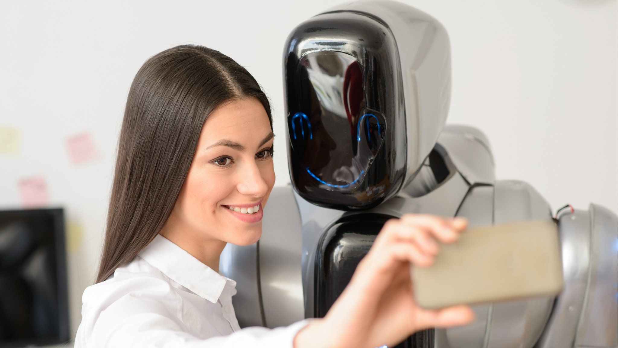 Woman taking selfie with robot